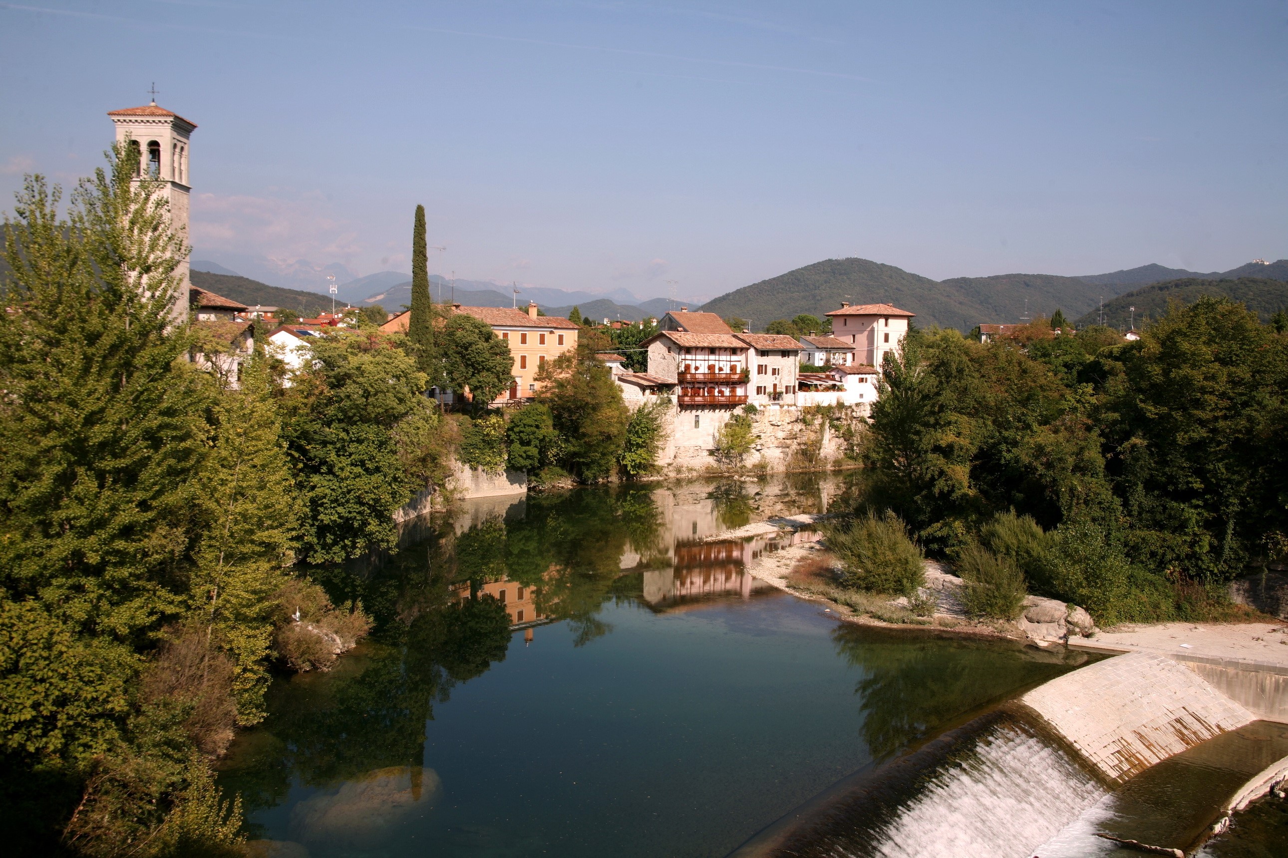 Town with bell tower on river in Cividale, Italy HD Wallpaper