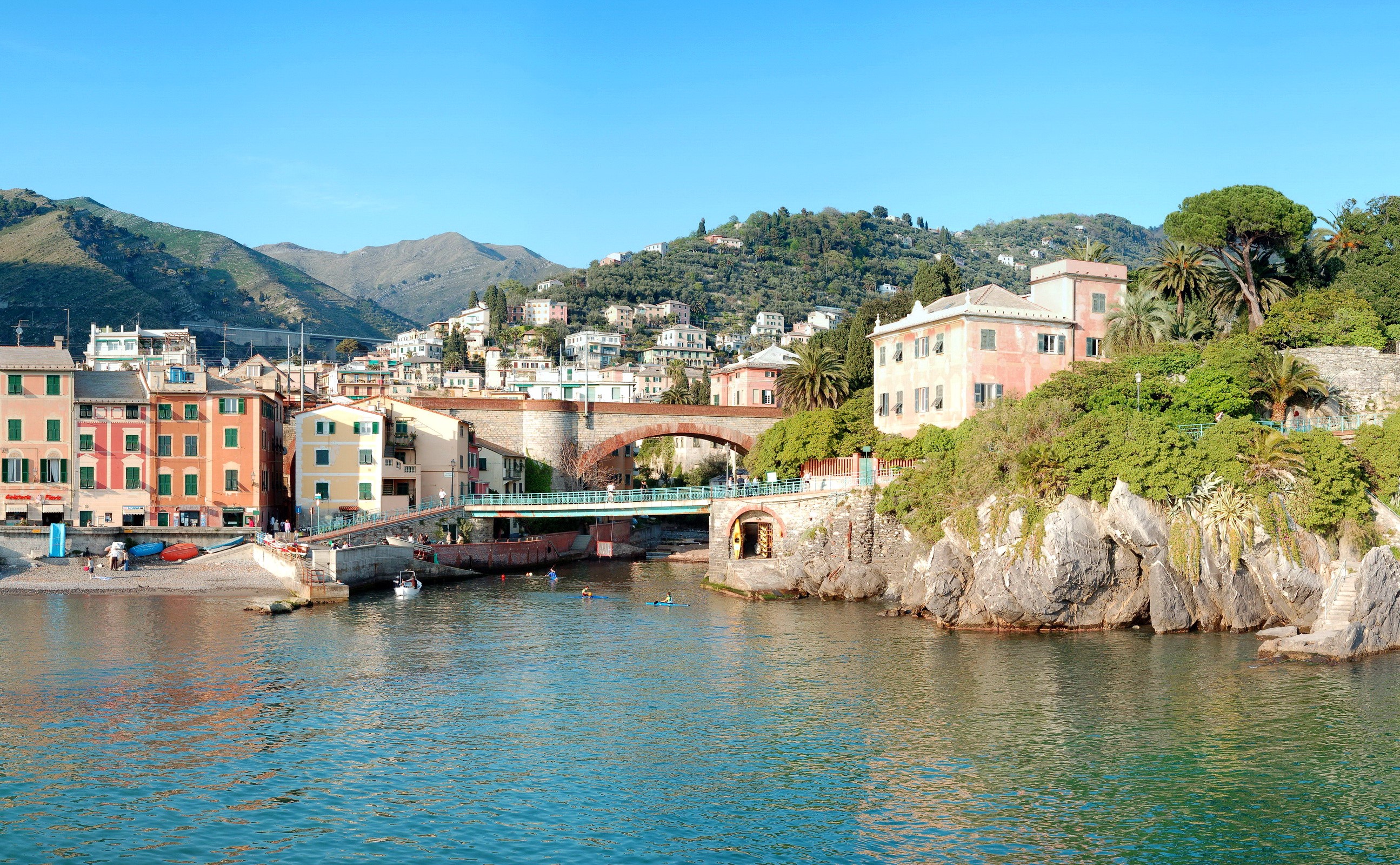 Coastal town with colorful buildings and a bridge in Italy HD Wallpaper
