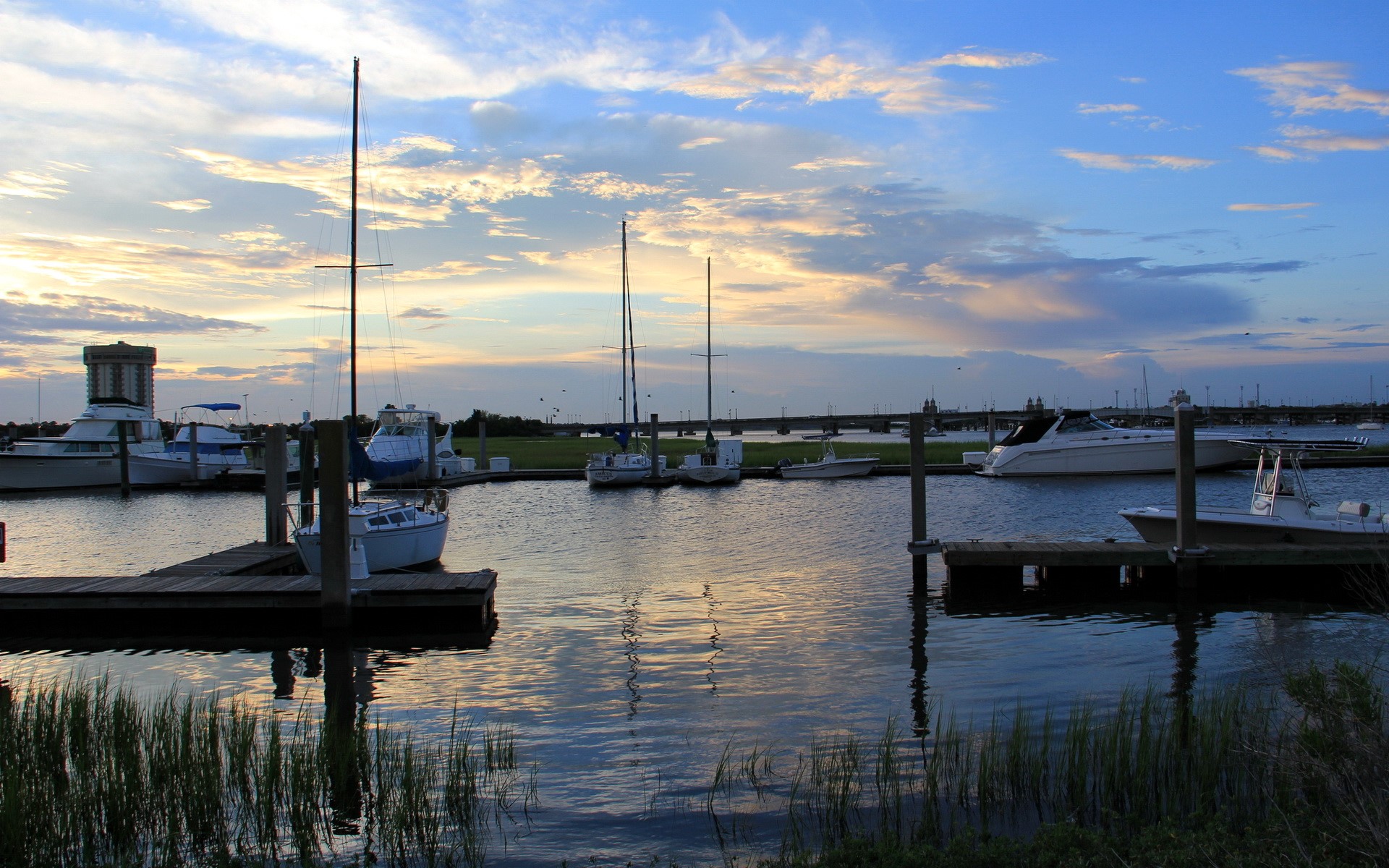 Boats docked in a harbor at sunset HD Wallpaper