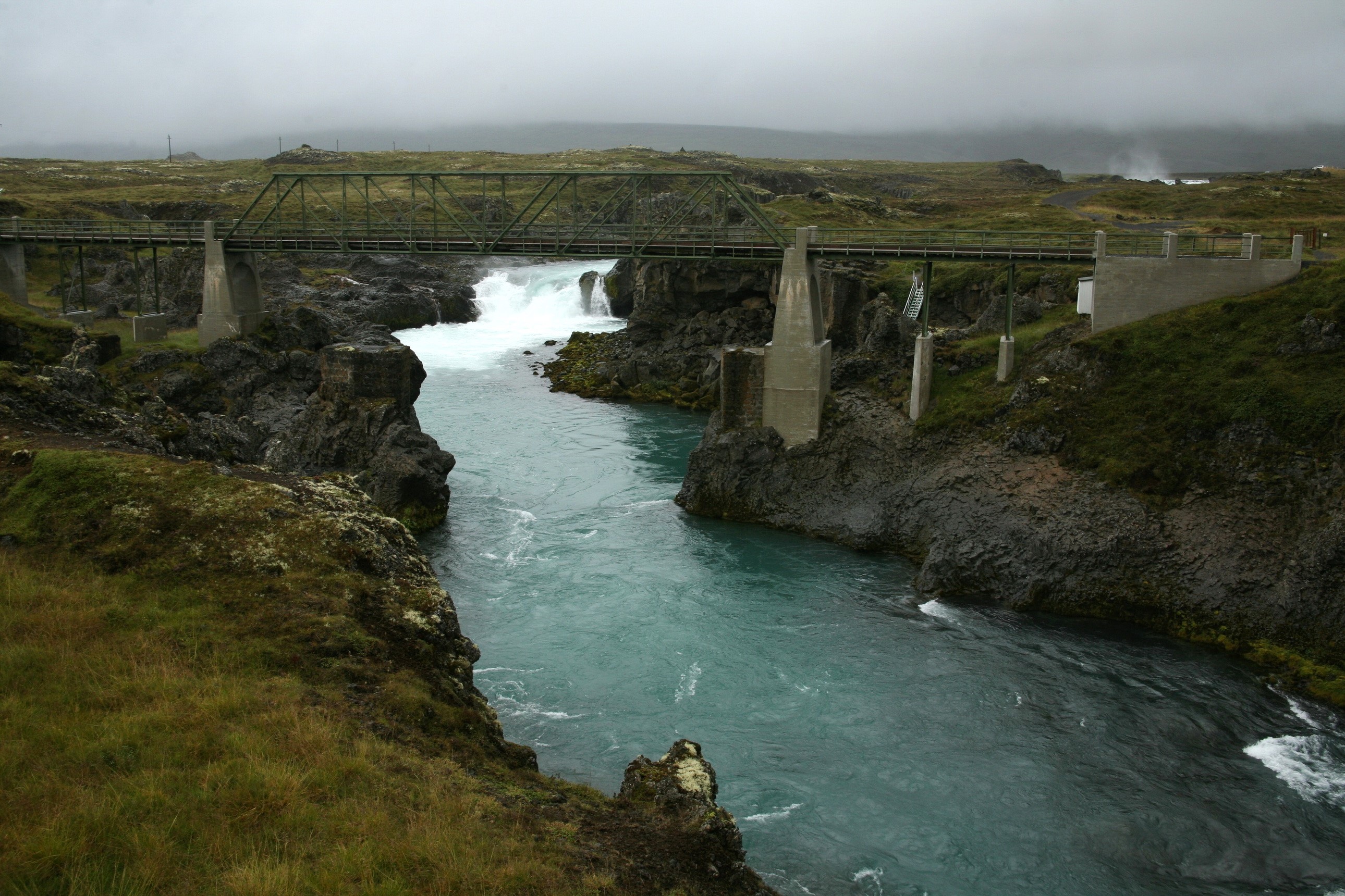 Bridge over a river with waterfalls HD Wallpaper
