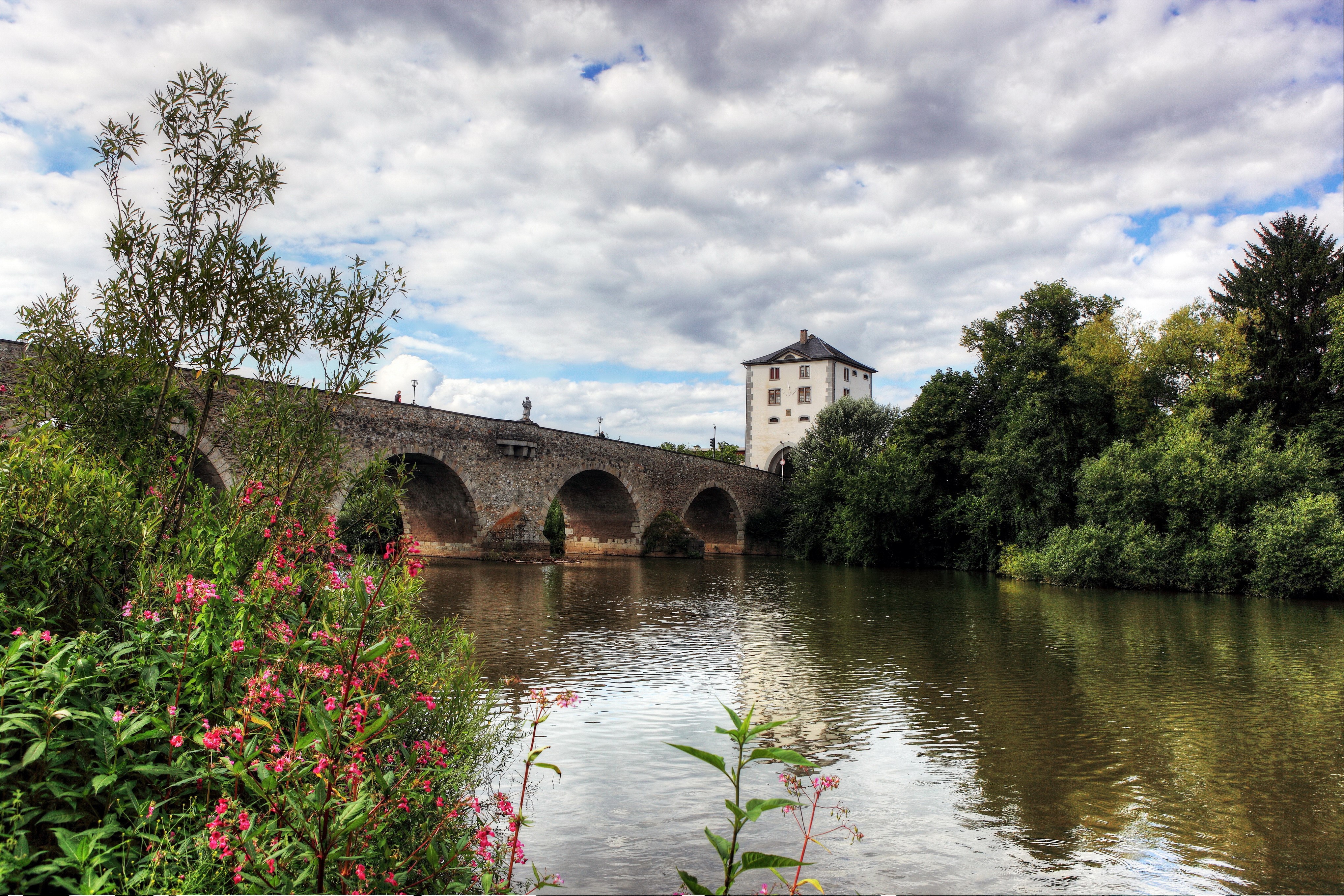Stone bridge over a river with a tower HD Wallpaper