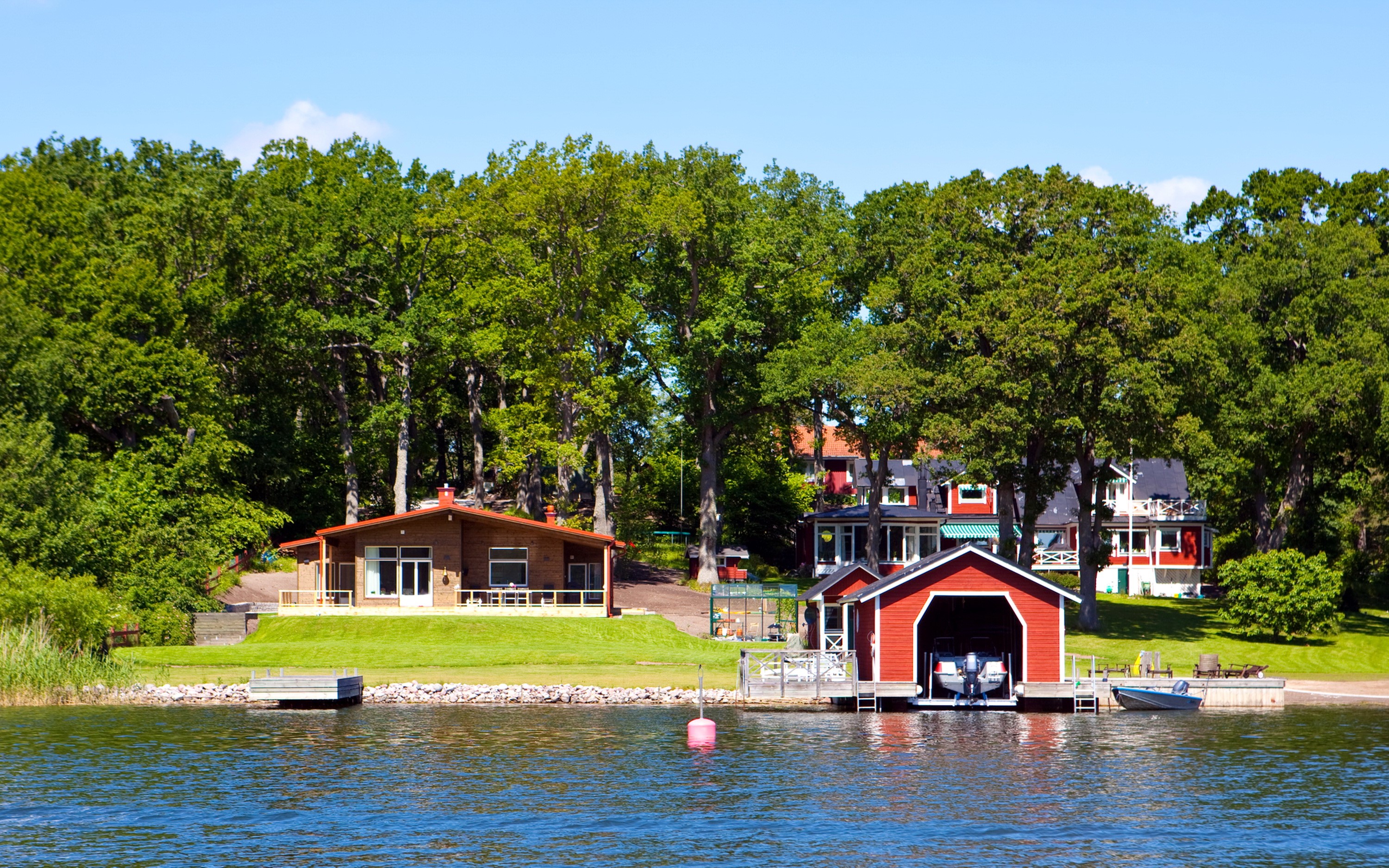Houses and boathouse on a lake in Sweden HD Wallpaper