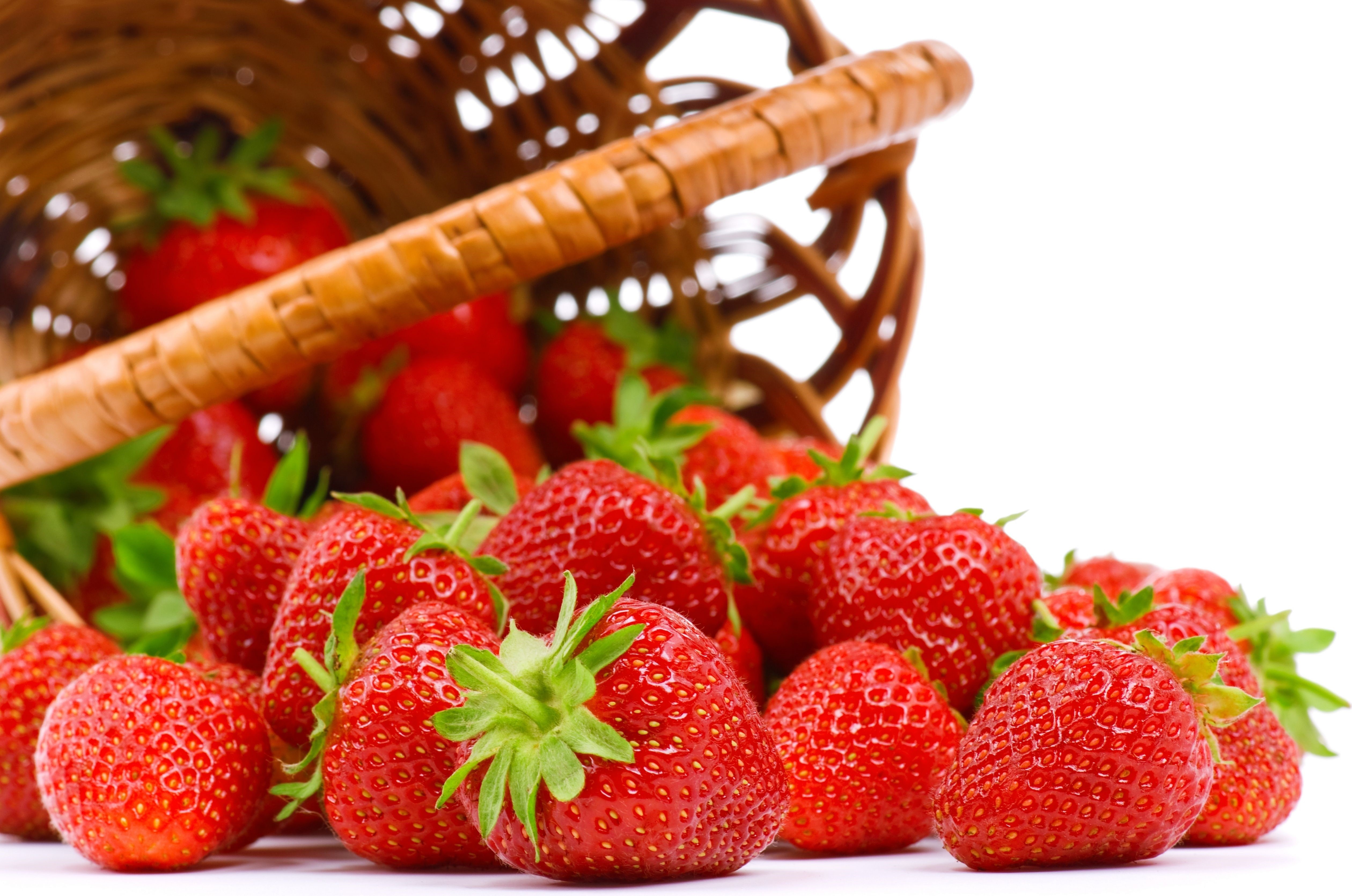 Strawberries spilling from a basket HD Wallpaper