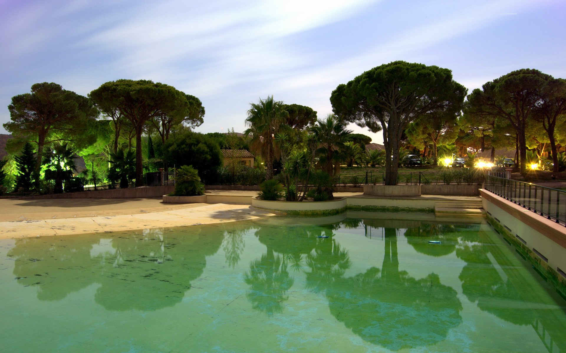 Empty swimming pool with trees and lights HD Wallpaper