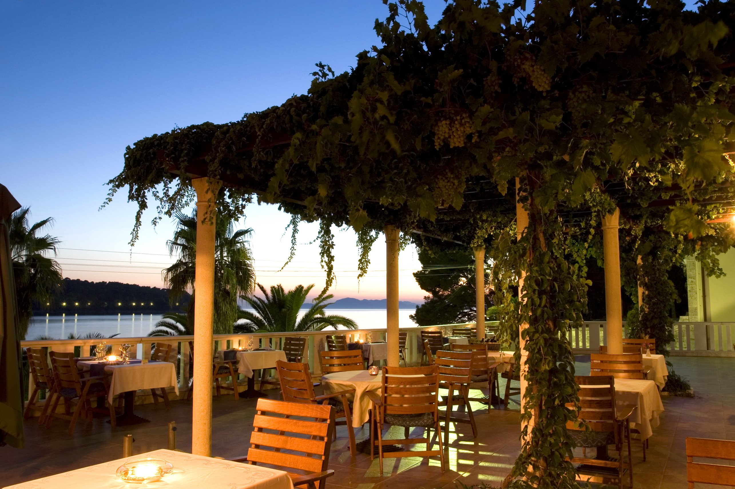 Outdoor restaurant terrace with sea view at dusk HD Wallpaper