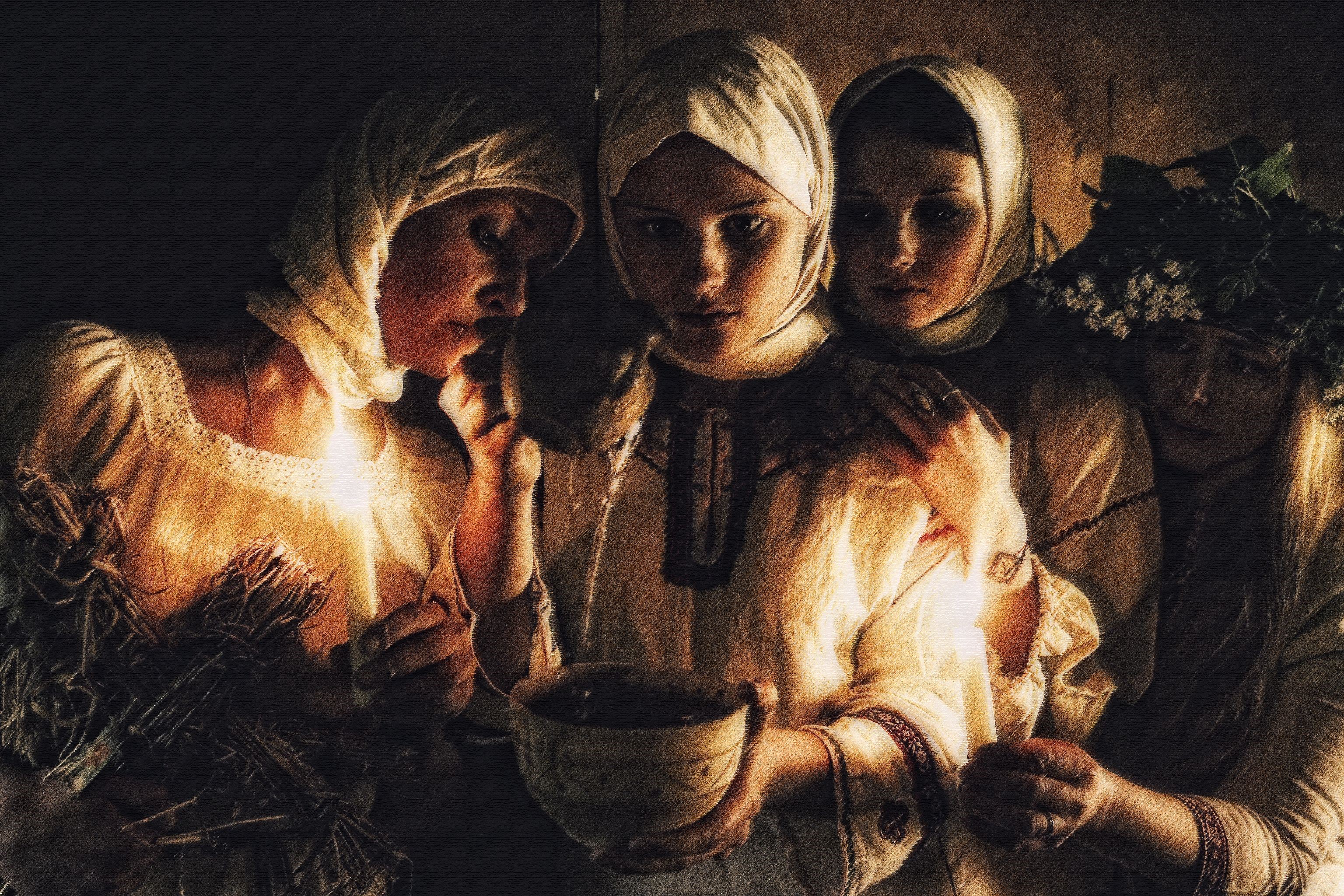 Four women in traditional clothing holding candles and a bowl HD Wallpaper
