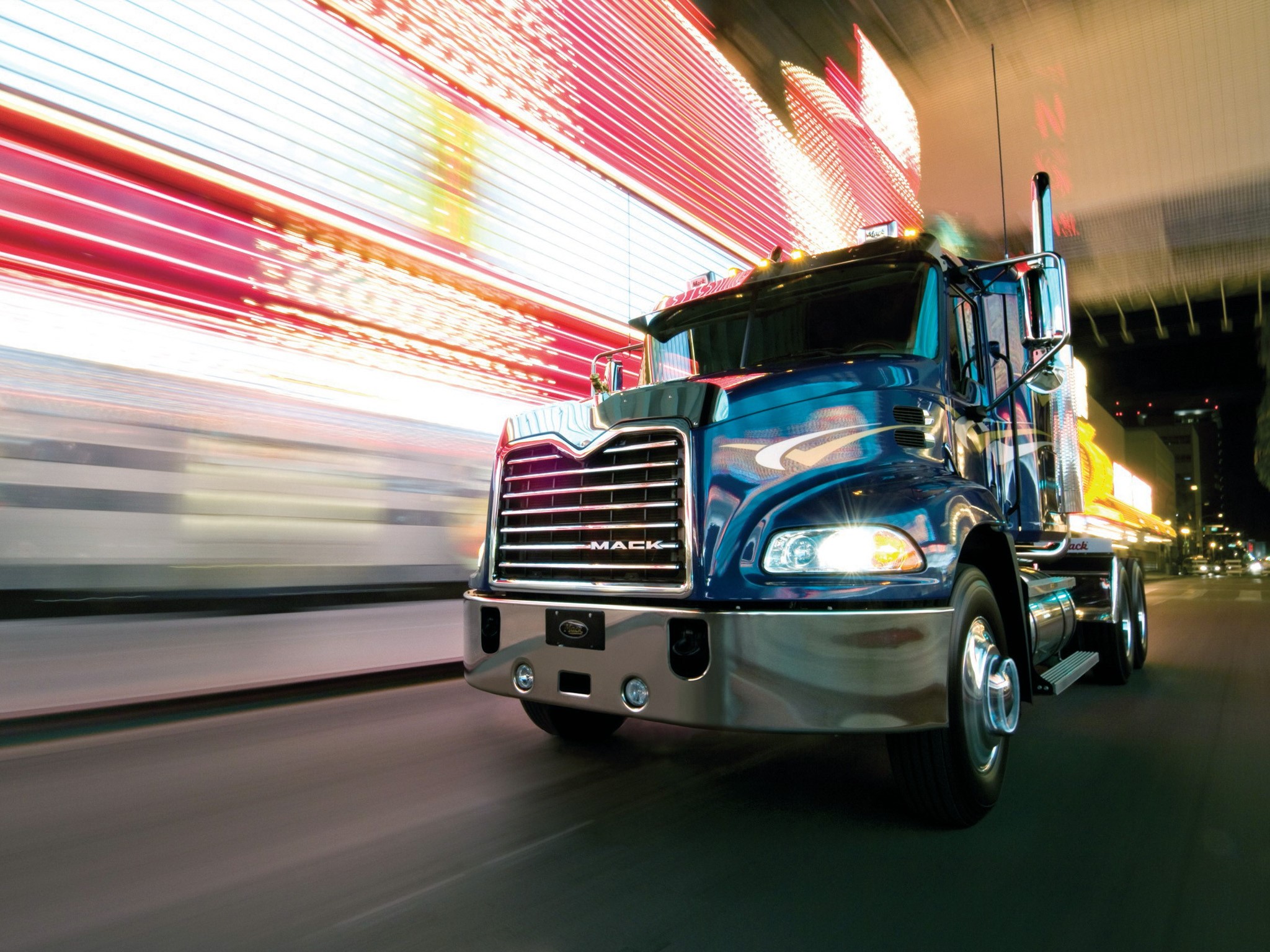 Blue Mack Truck Driving at Night with Light Streaks HD Wallpaper