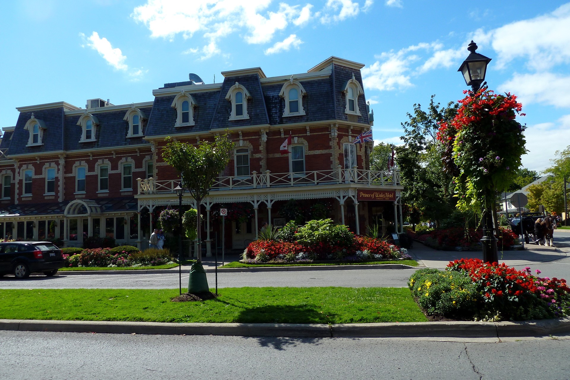 Prince of Wales Hotel building with flowers and trees HD Wallpaper