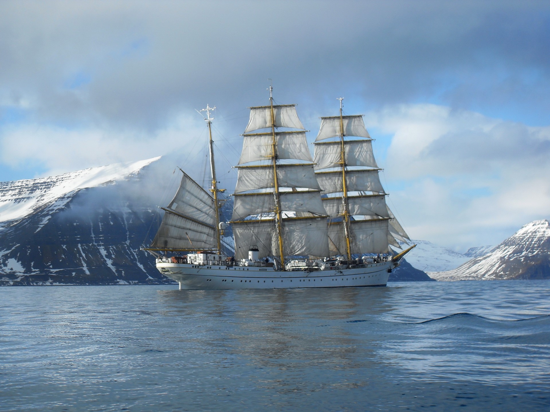 Tall Ship Sailing in Snowy Mountains HD Wallpaper