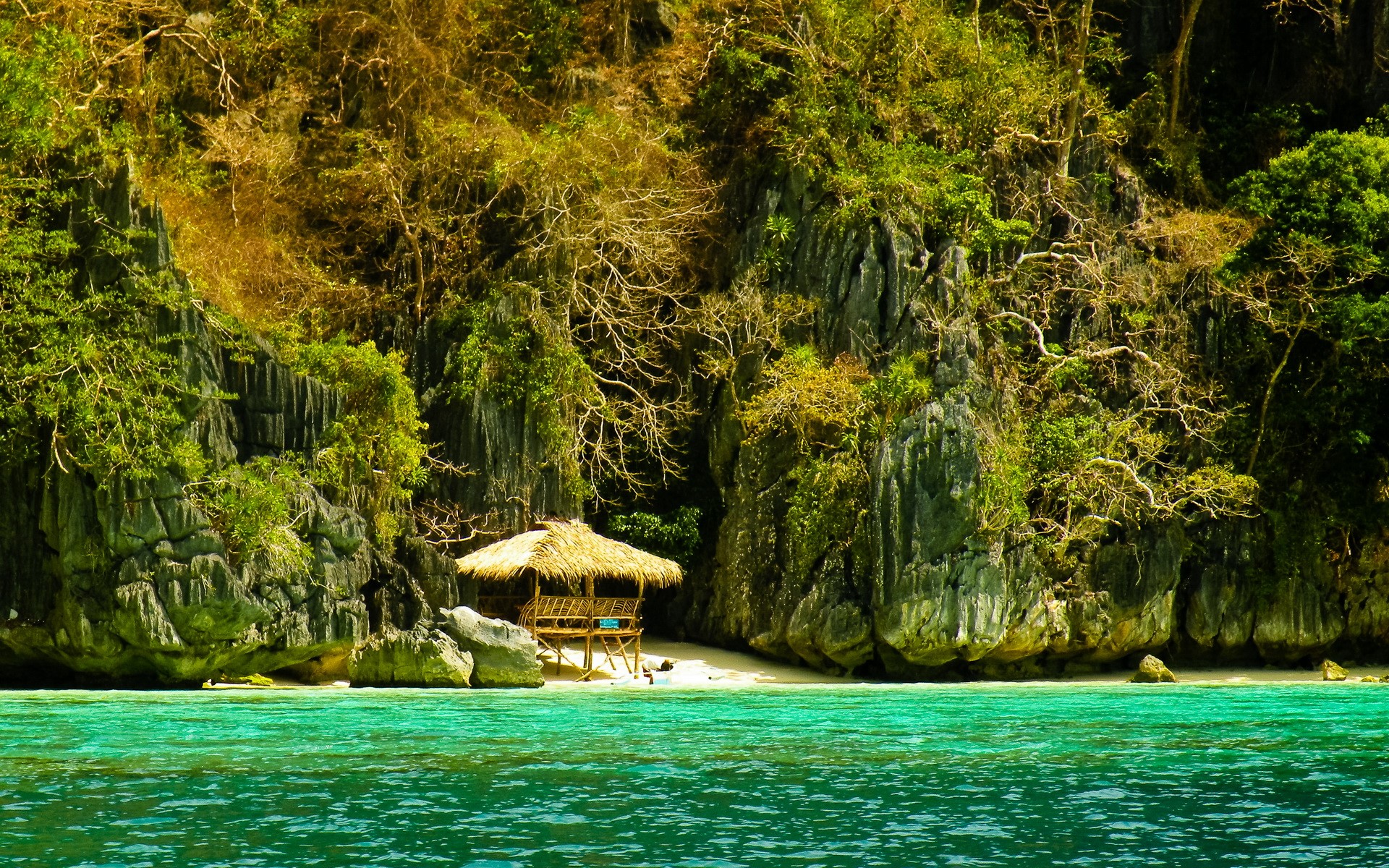 Tropical beach hut on a rocky island HD Wallpaper