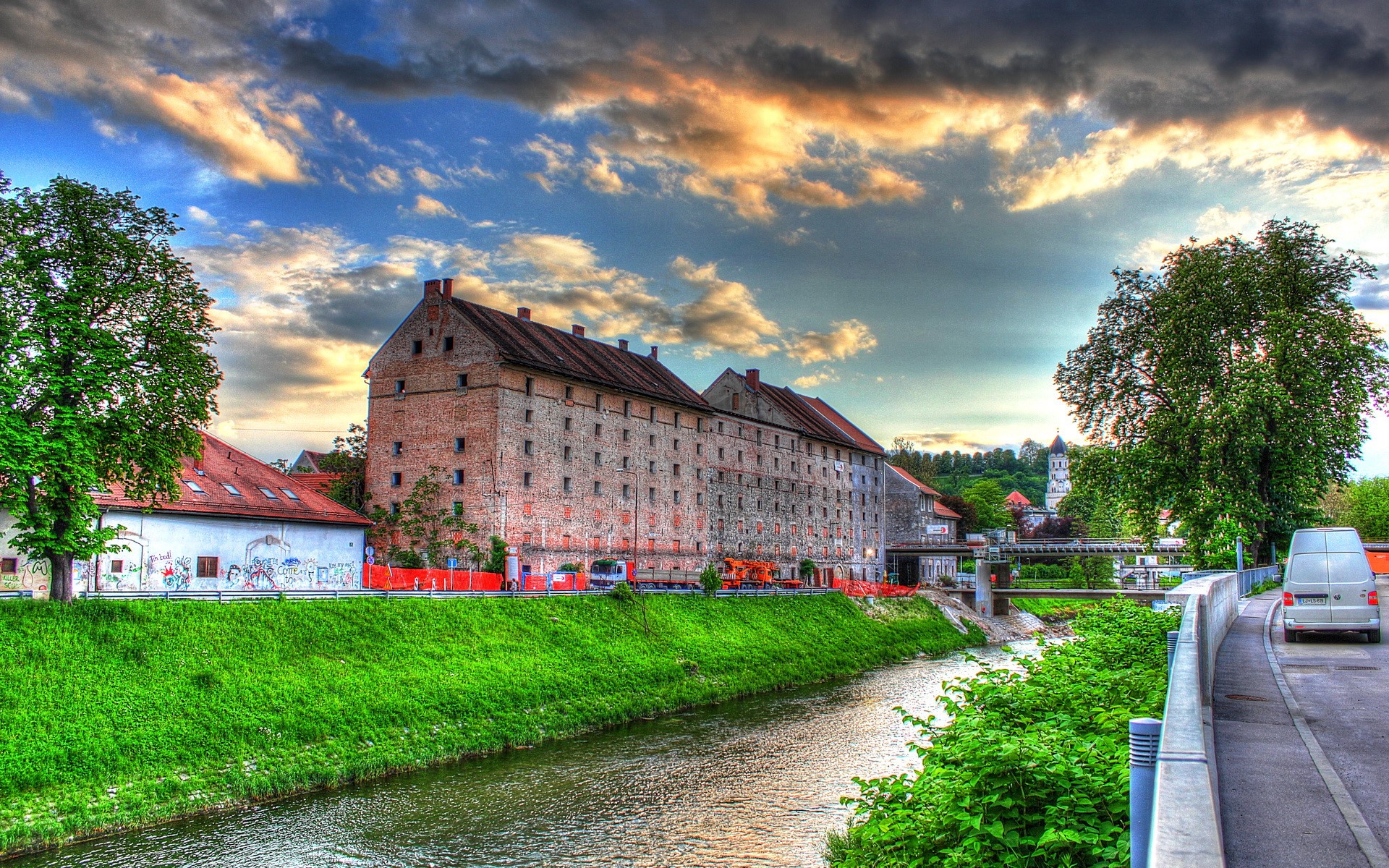 Old brick buildings along a river in Slovenia HD Wallpaper