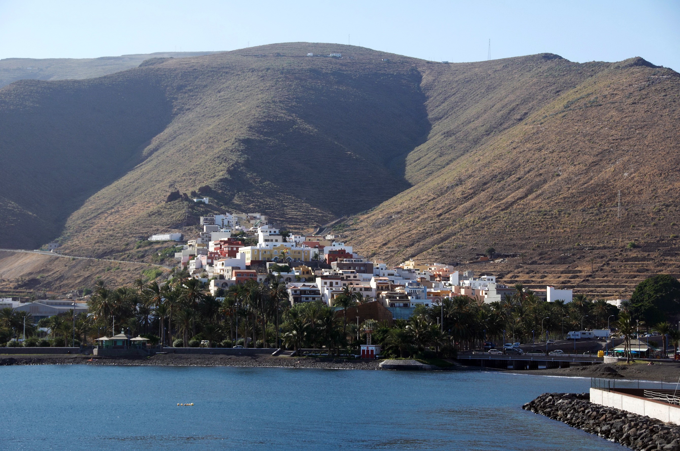 Coastal town nestled against a mountain in Spain HD Wallpaper