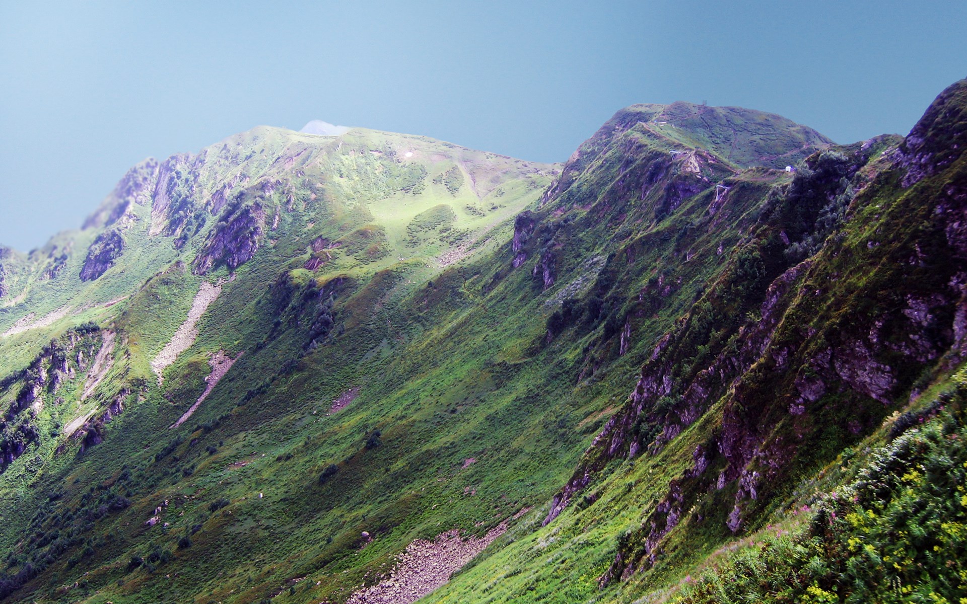 Green mountain slopes under a clear sky HD Wallpaper