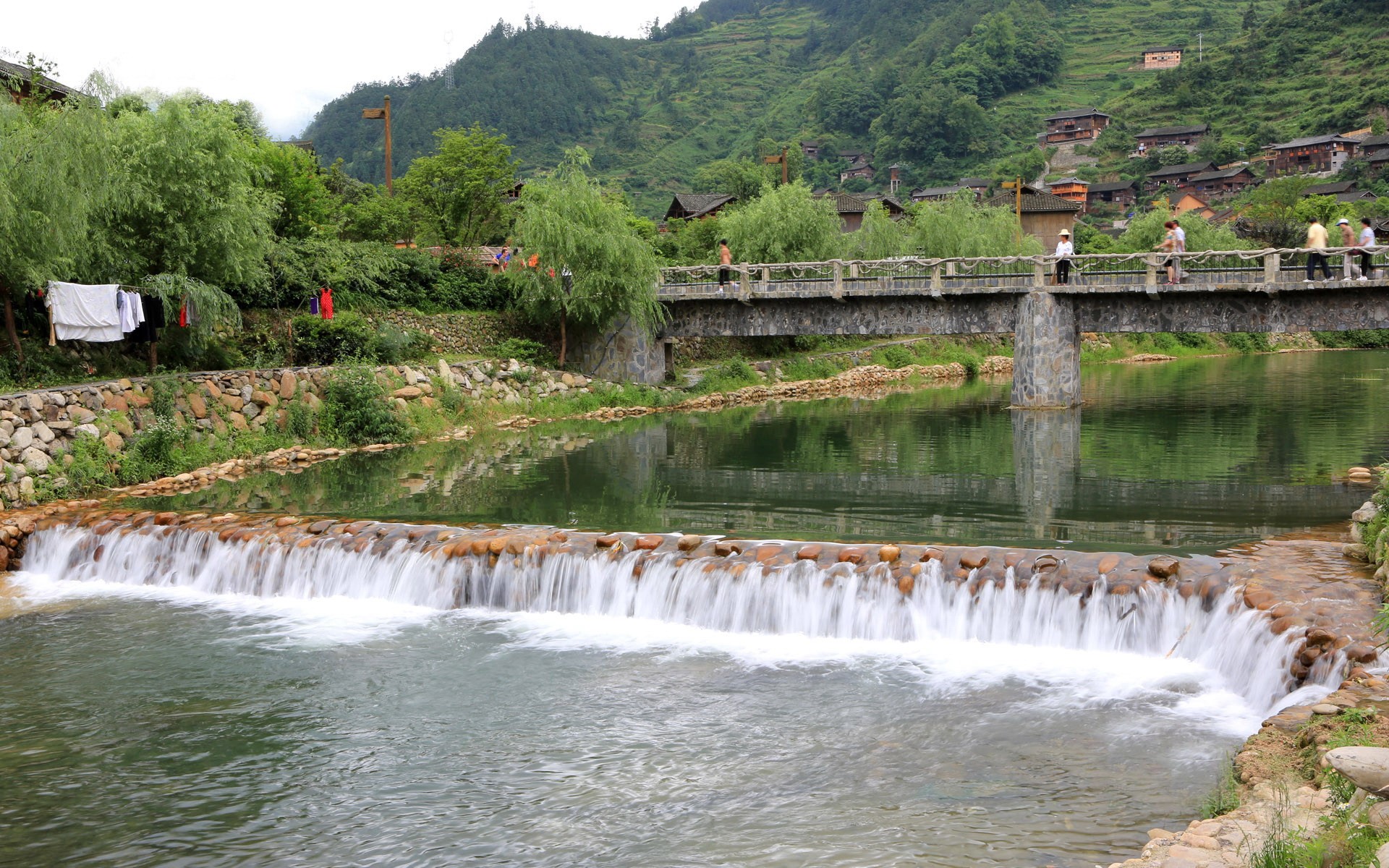 River with a small waterfall and a bridge HD Wallpaper