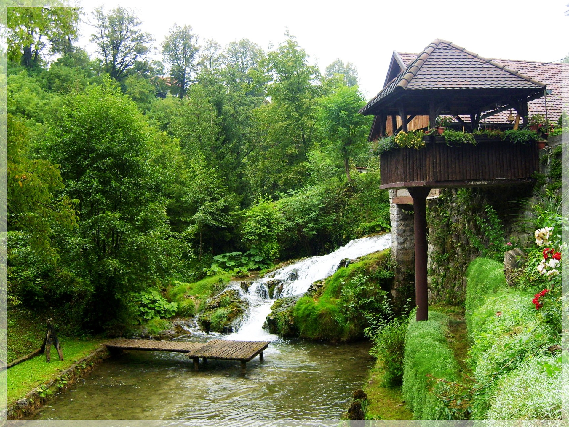 Wooden gazebo overlooking a waterfall and stream HD Wallpaper