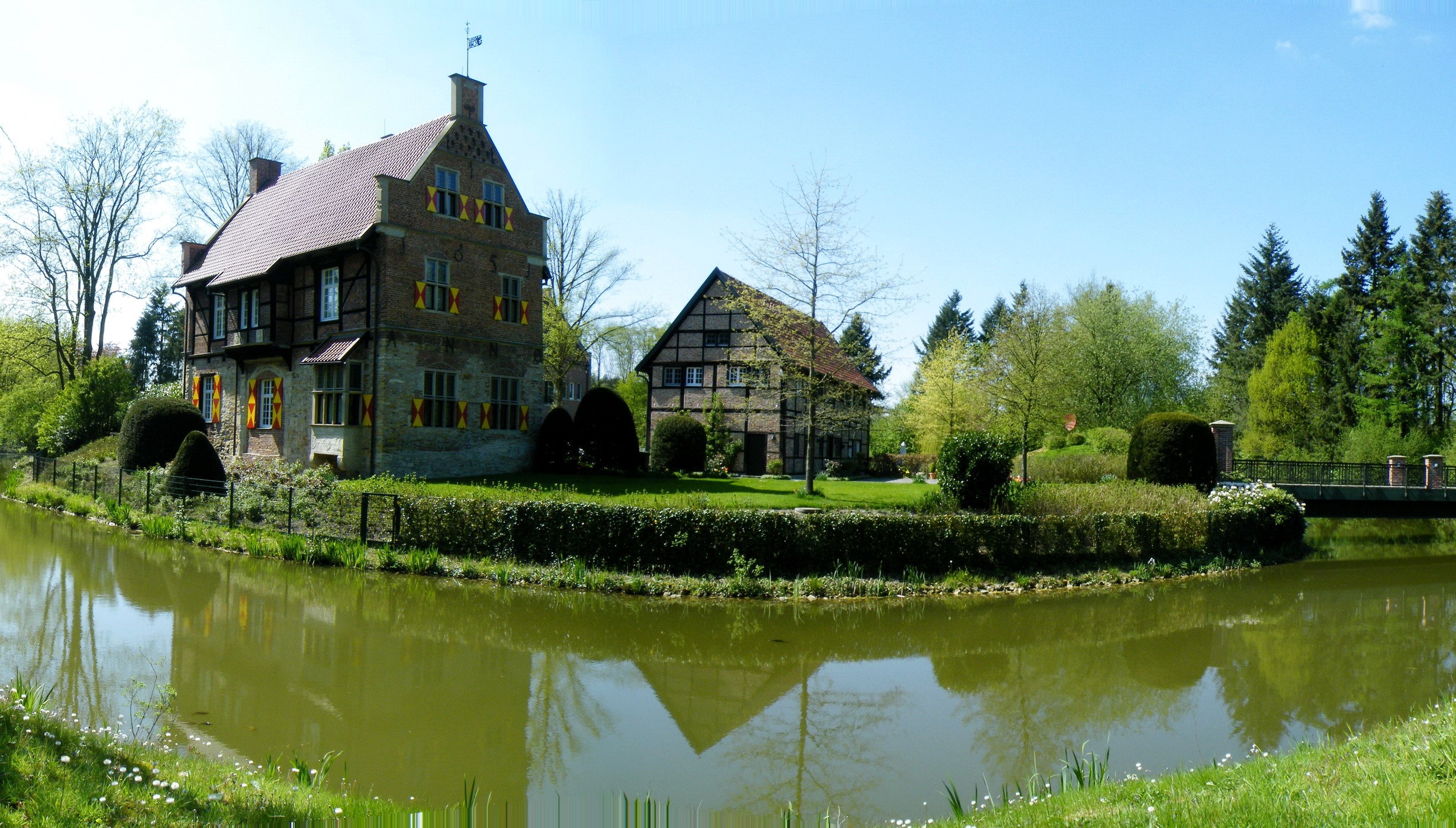 Castle with moat and surrounding trees in Germany HD Wallpaper
