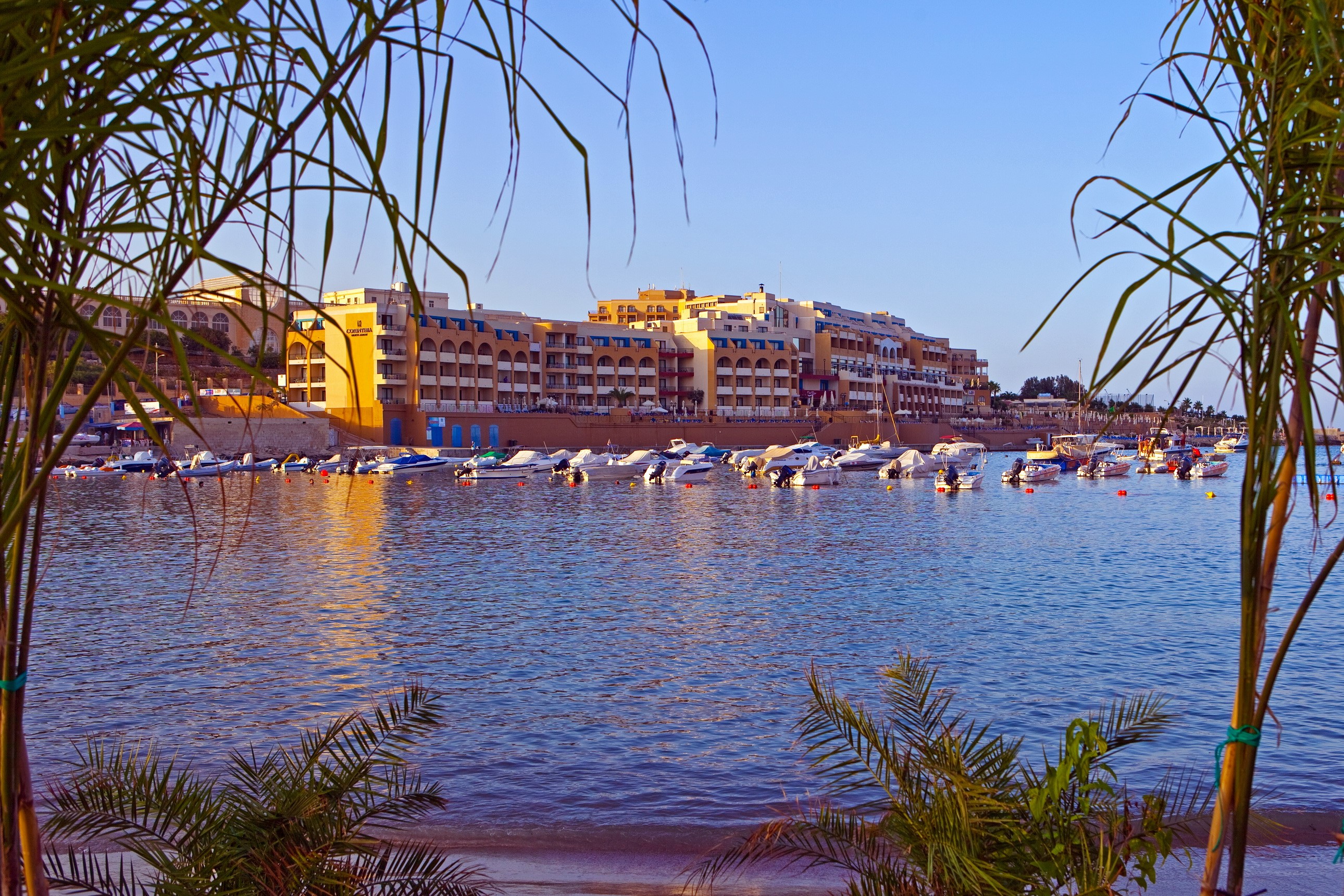 Boats docked in a harbor with buildings in Malta HD Wallpaper