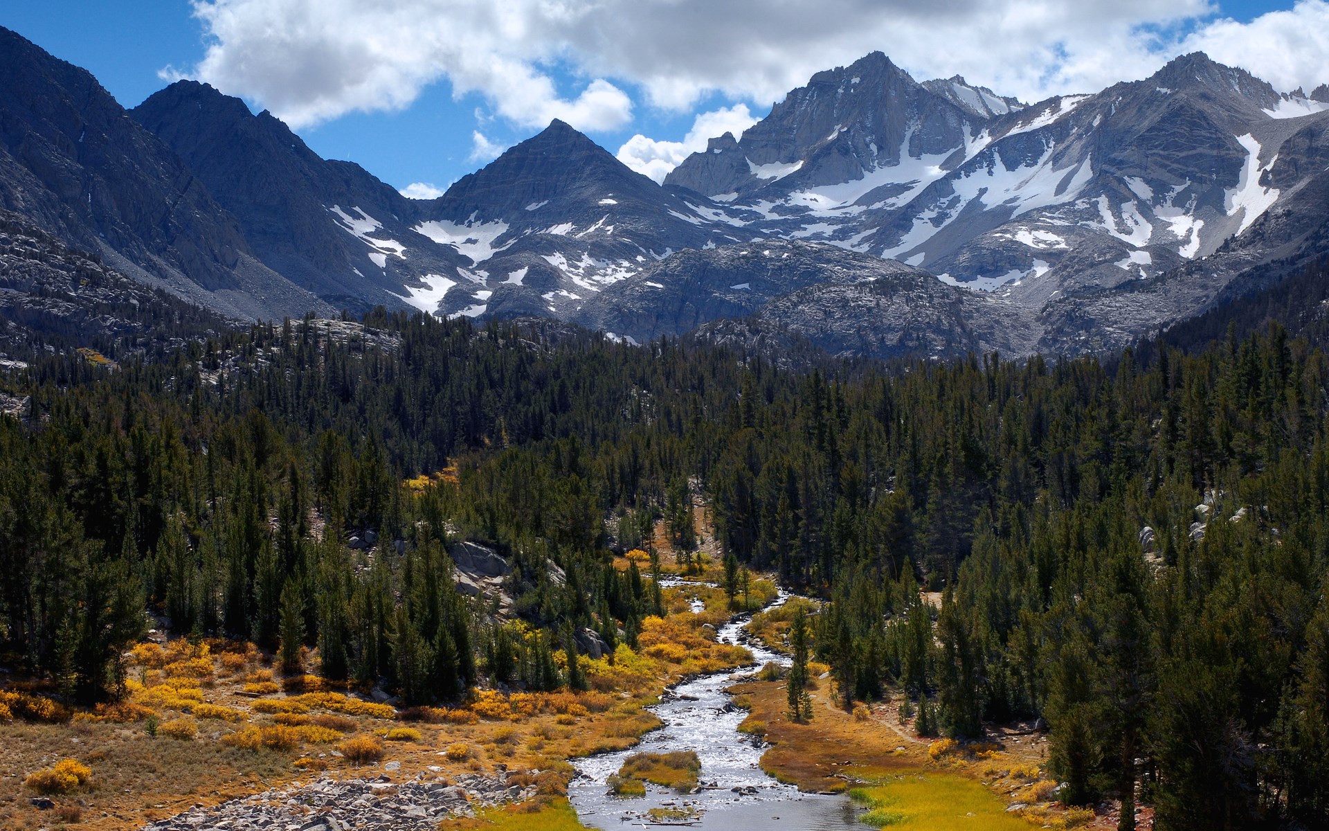 Mountain range with snow and forest and river HD Wallpaper