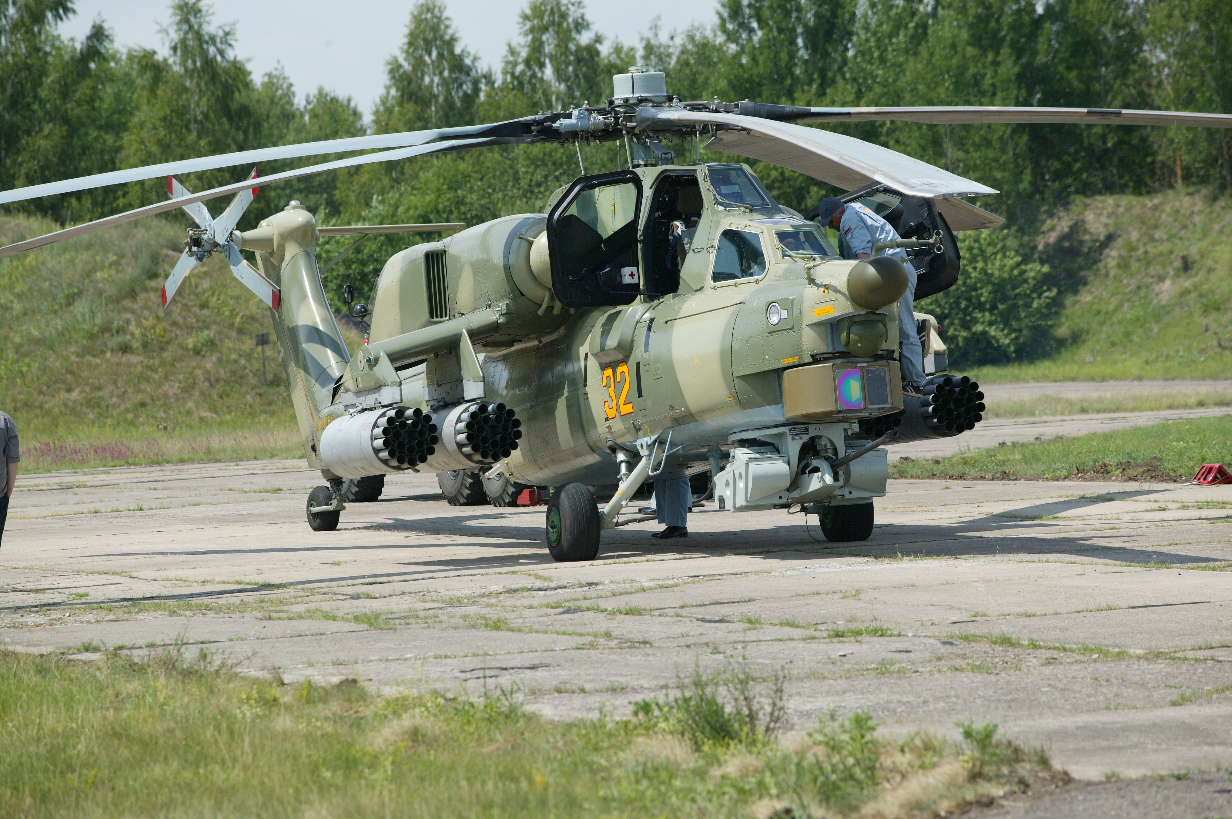 Military helicopter with number 32 on tarmac HD Wallpaper