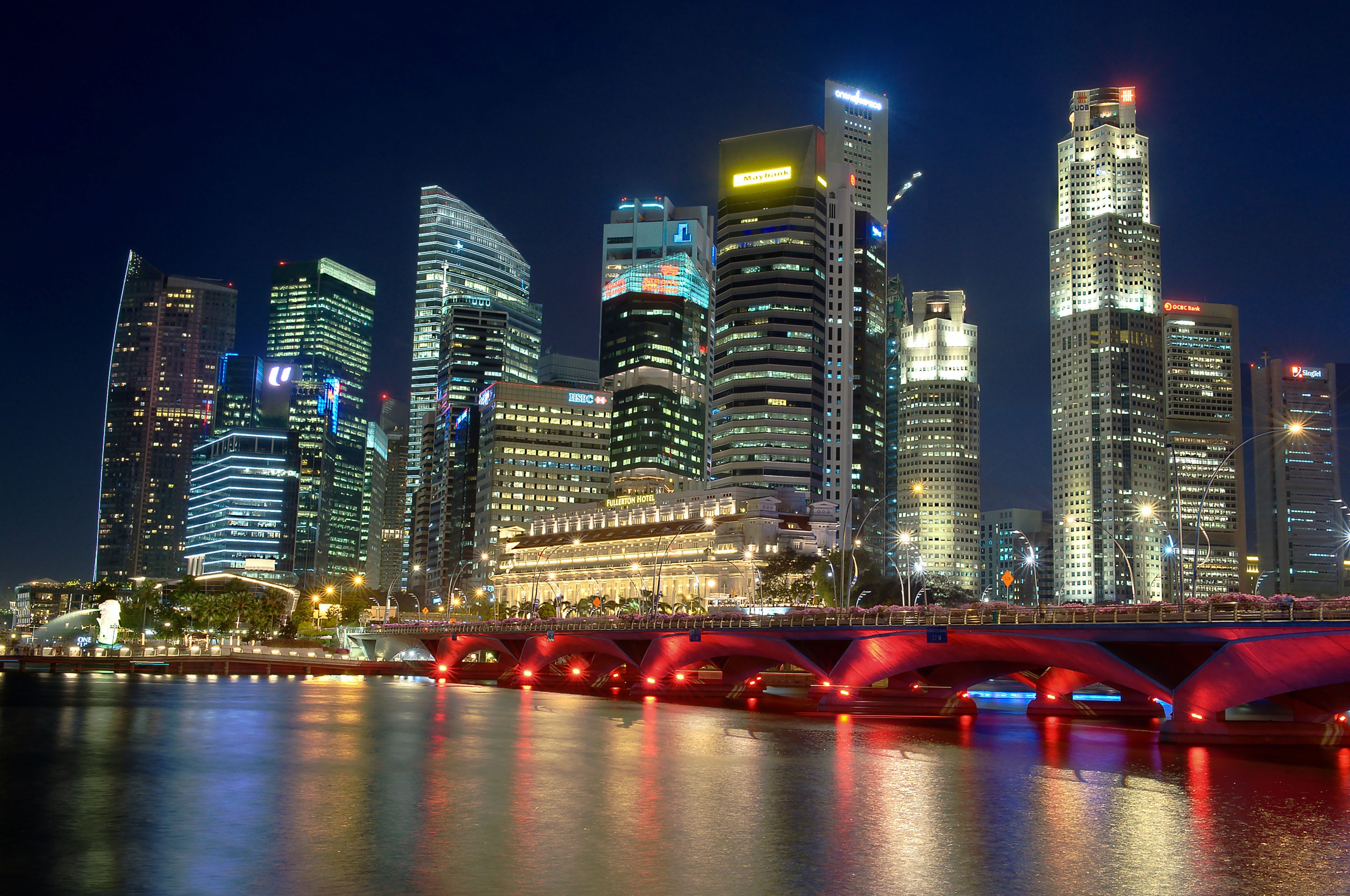 Singapore skyline at night with illuminated bridge HD Wallpaper