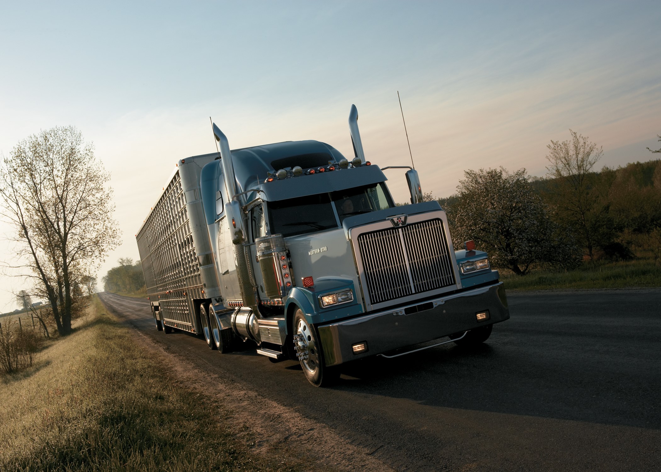 Western Star truck driving on a rural road HD Wallpaper