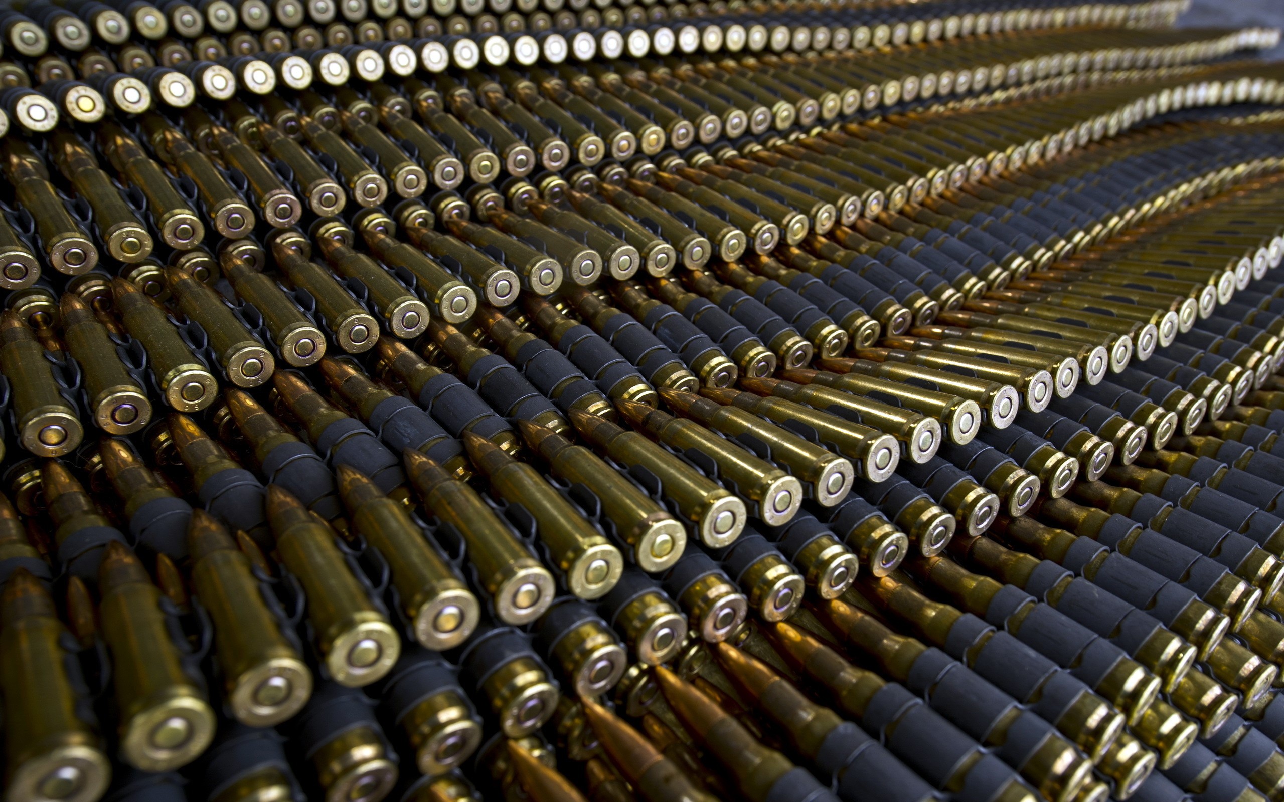 Rows of ammunition belts with brass cartridges HD Wallpaper