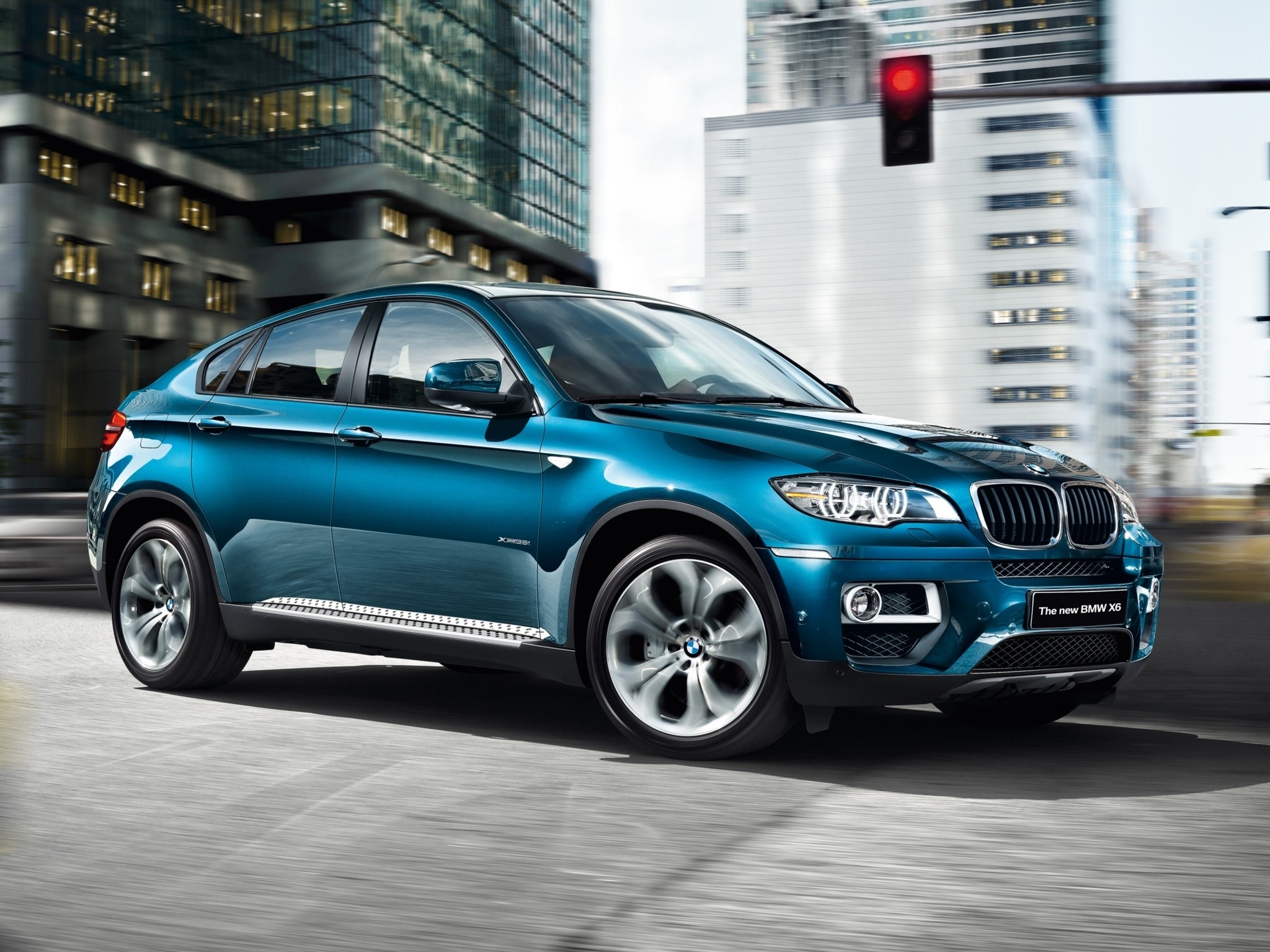 Blue BMW X6 driving in a city HD Wallpaper