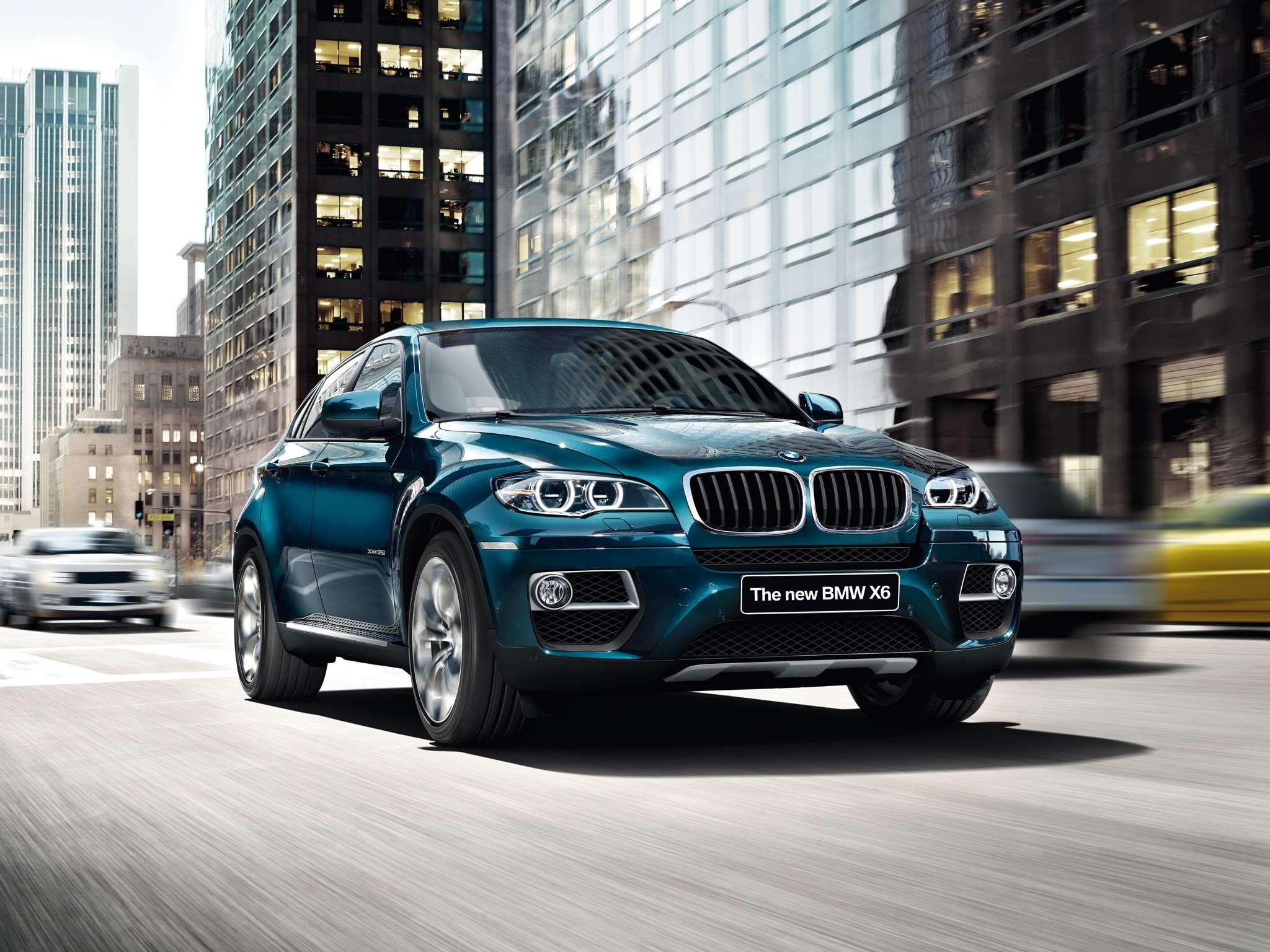 The new BMW X6 driving in a city HD Wallpaper