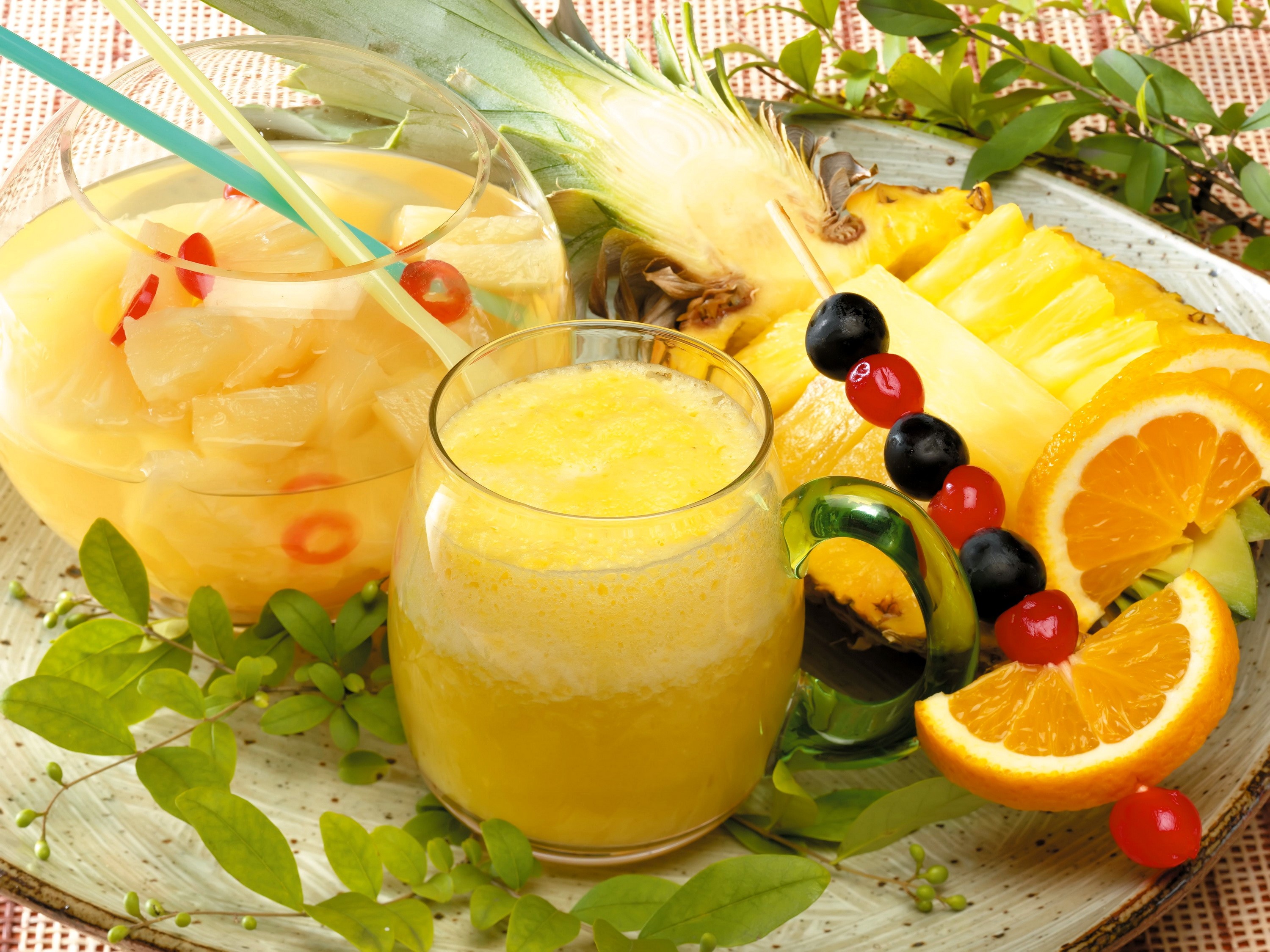 Pineapple and orange juice with fruit garnish HD Wallpaper