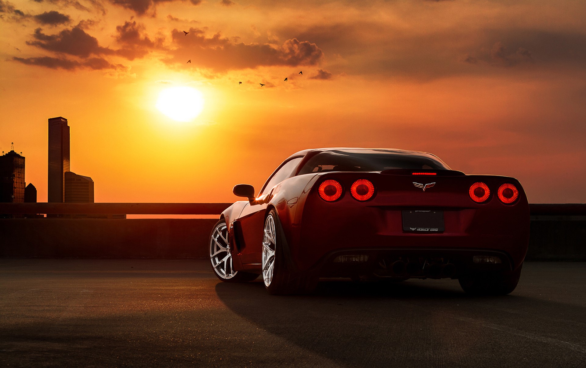 Red Chevrolet Corvette at Sunset with City Skyline HD Wallpaper