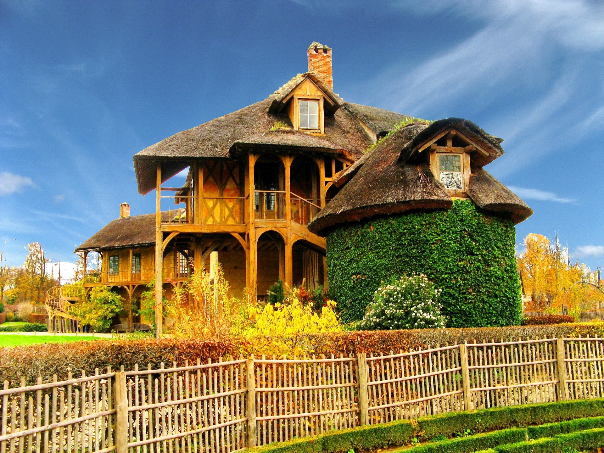 Thatched roof cottage with ivy-covered tower in France HD Wallpaper