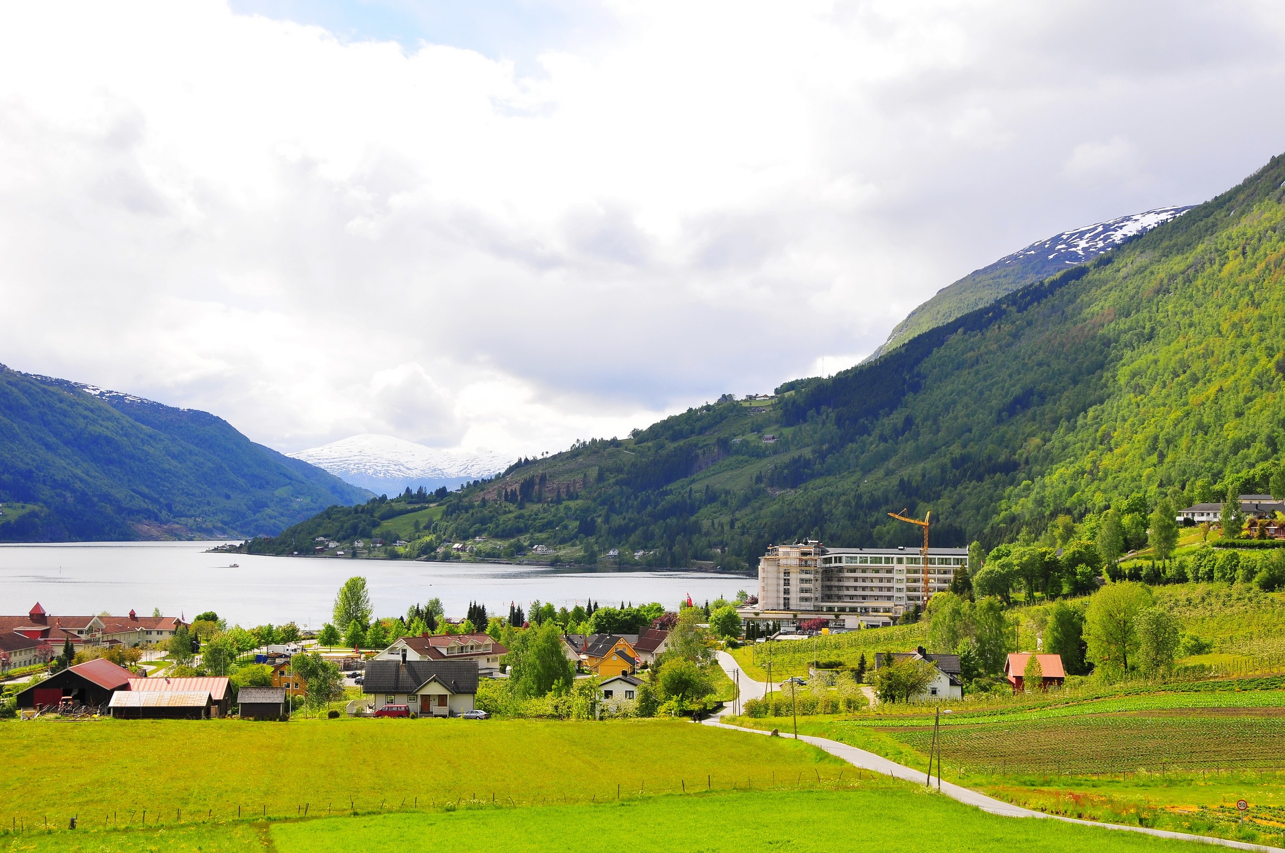 Village by a fjord in Norway with mountains HD Wallpaper