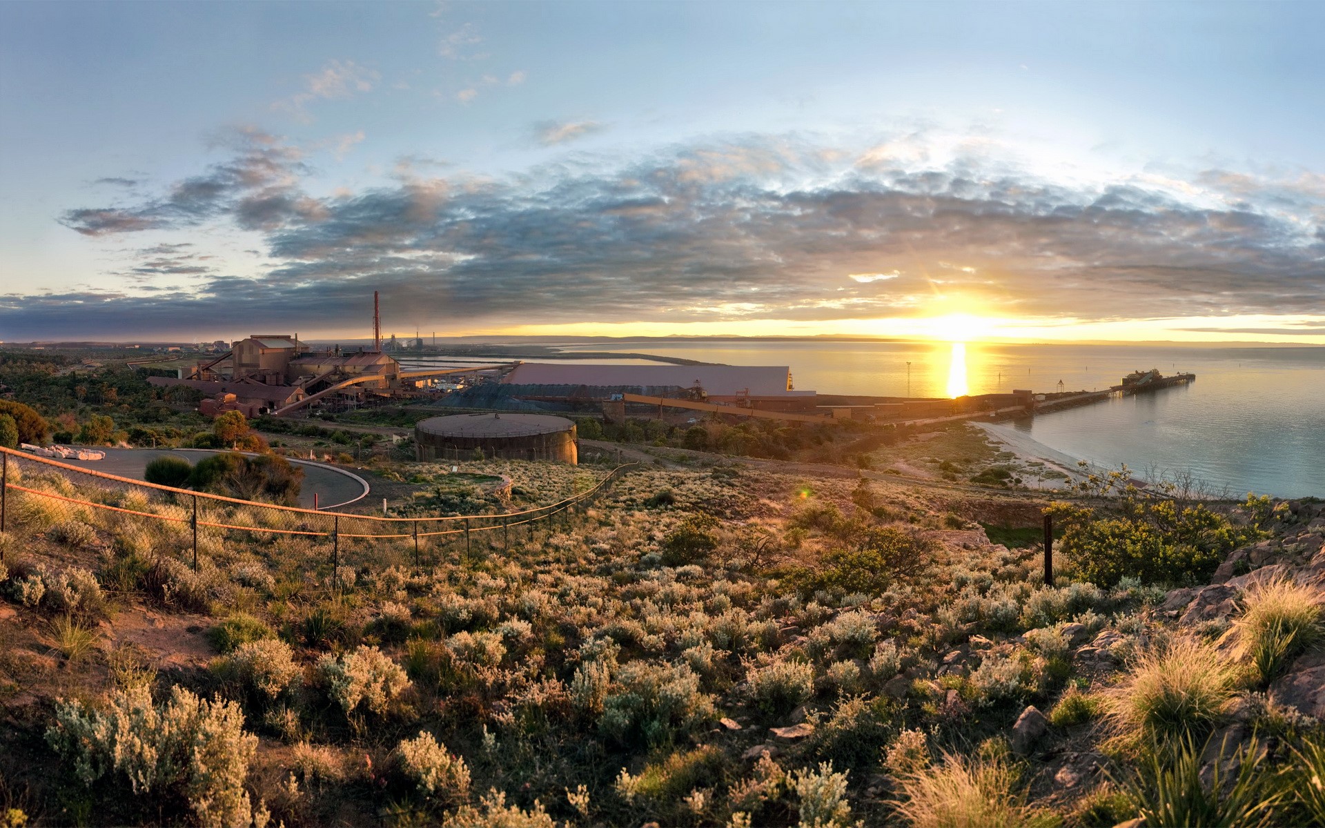Industrial complex by the sea at sunset HD Wallpaper