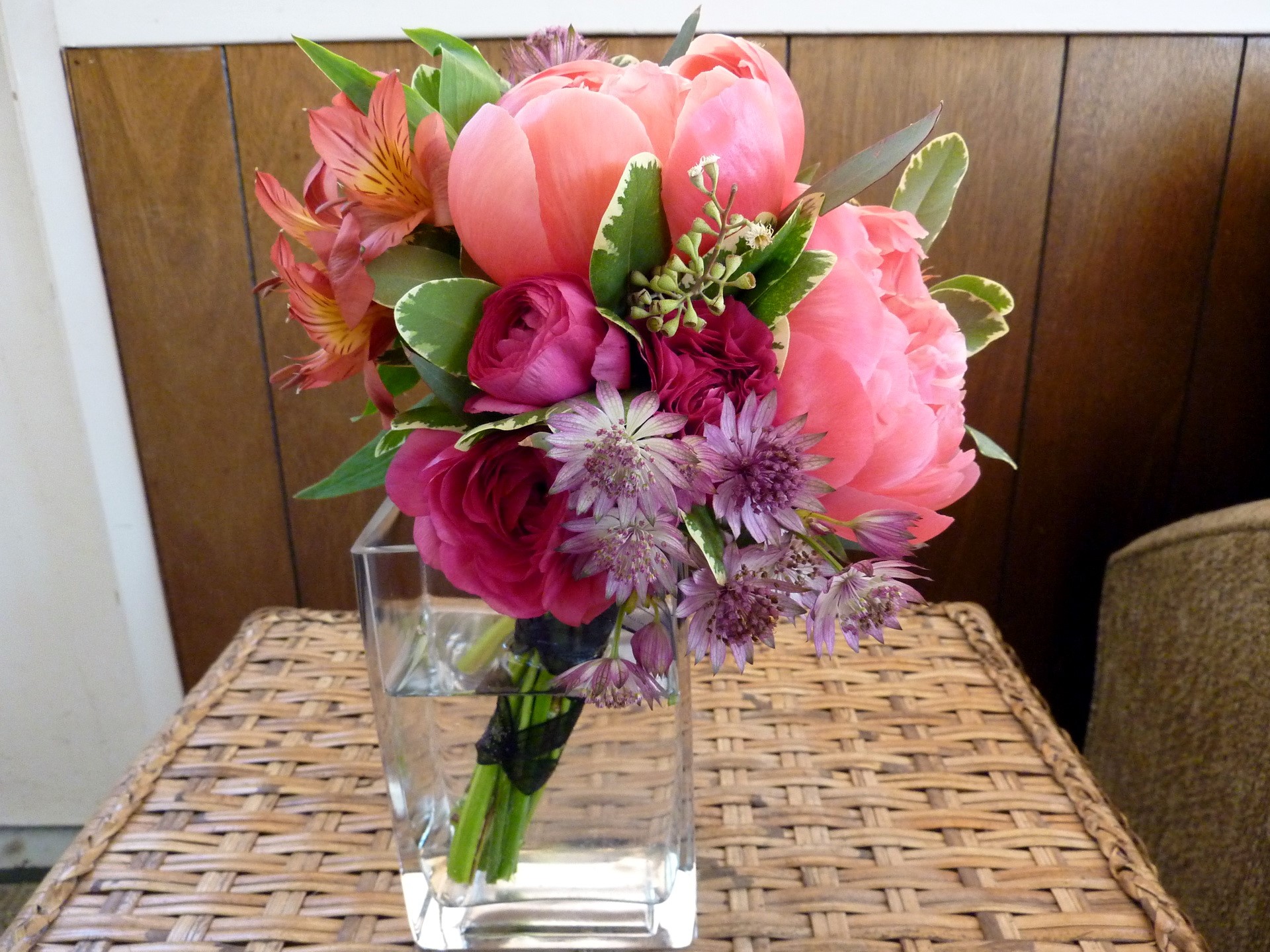 Pink and coral peony bouquet in a glass vase HD Wallpaper