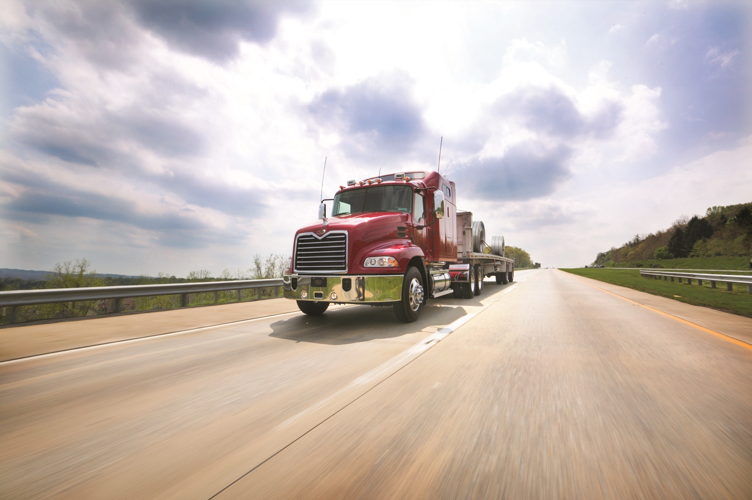 Red Mack Truck driving on a highway HD Wallpaper