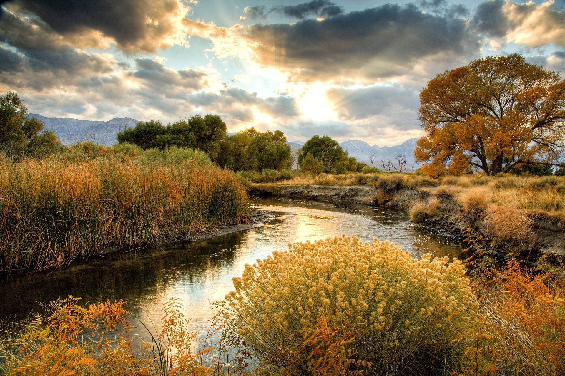 River flowing through autumn landscape with mountains HD Wallpaper
