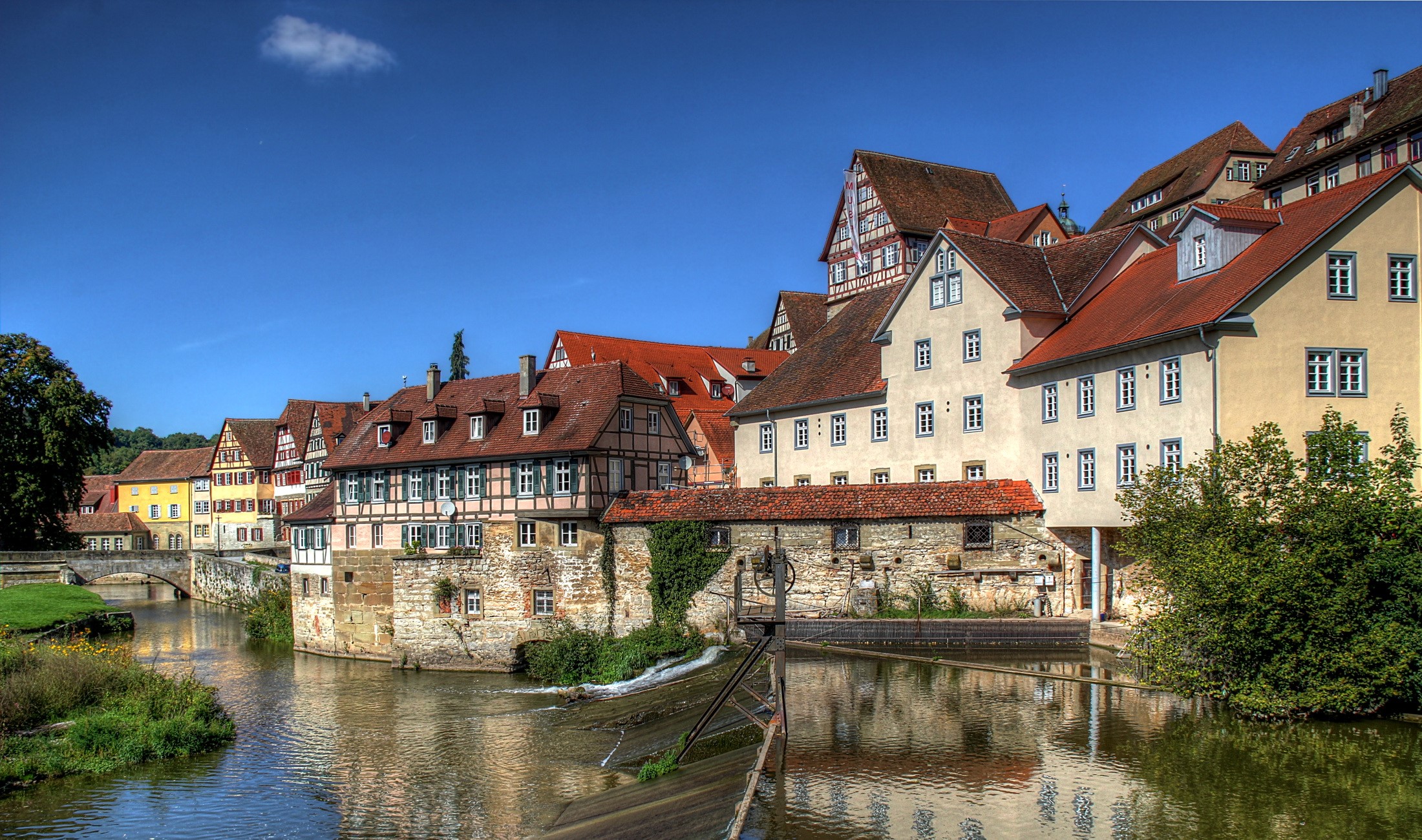 Half-timbered houses along a river in Germany HD Wallpaper