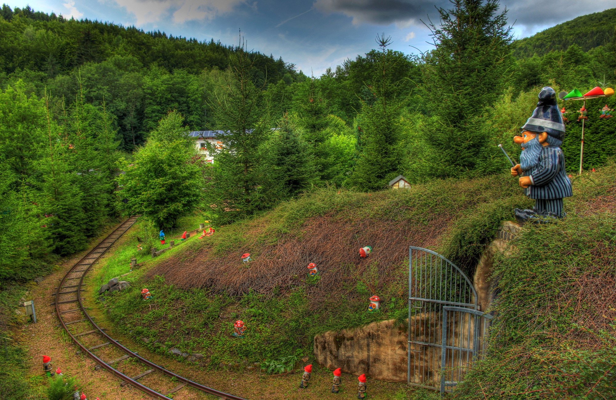 Gnome figures and miniature railway in a park HD Wallpaper