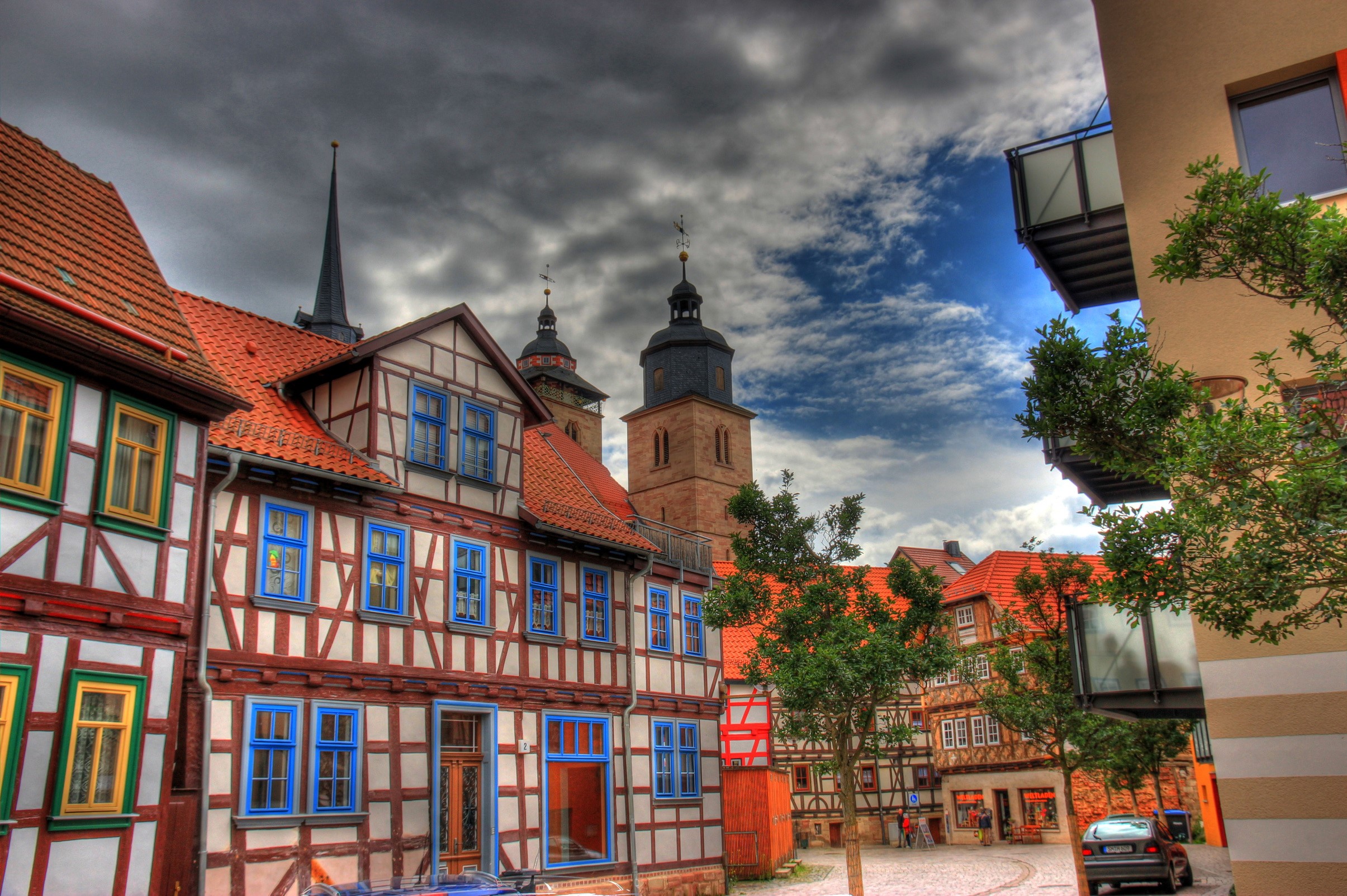 Half-timbered houses and church towers in Germany HD Wallpaper