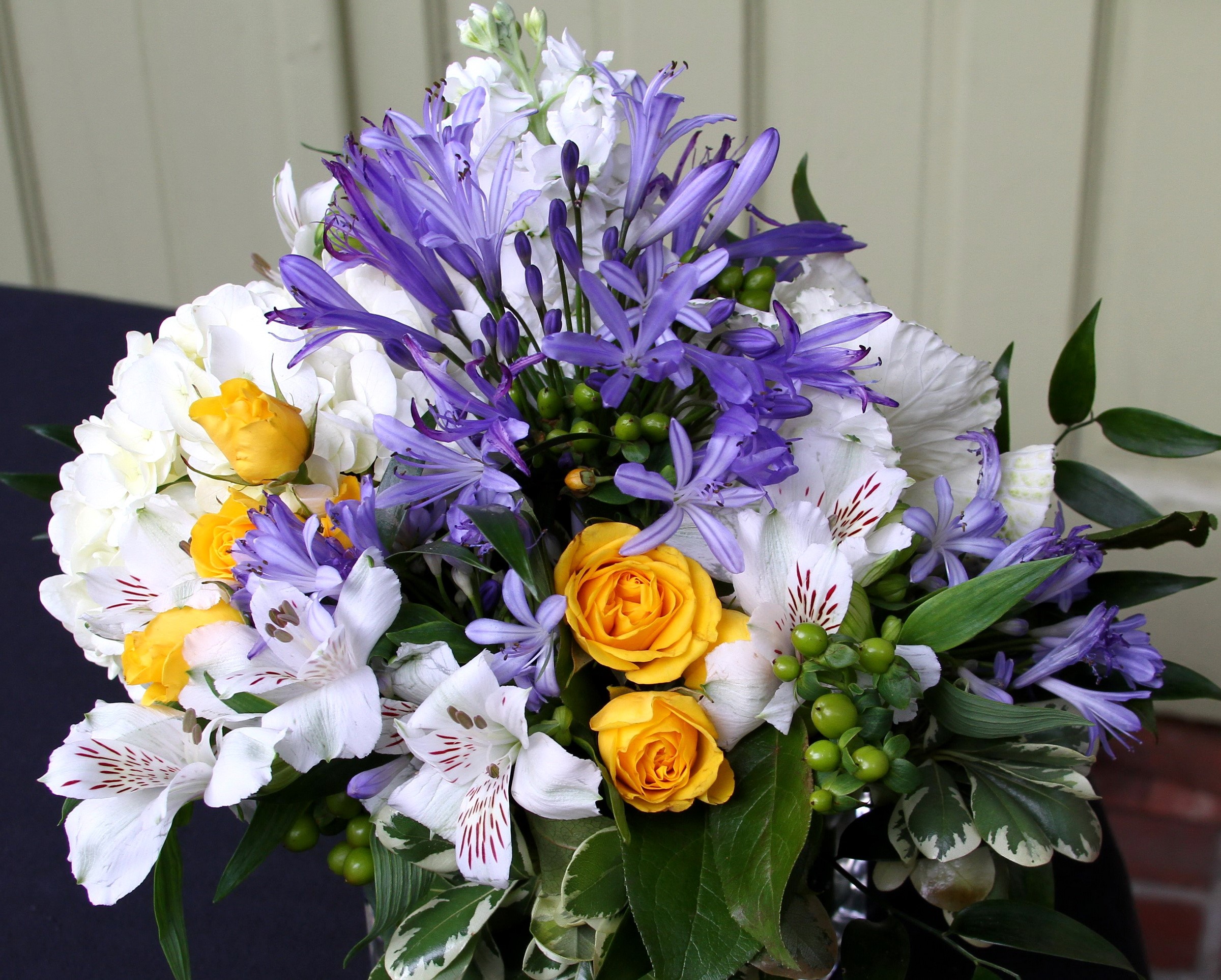 Bouquet of yellow roses, white hydrangeas, and purple agapanthus HD Wallpaper