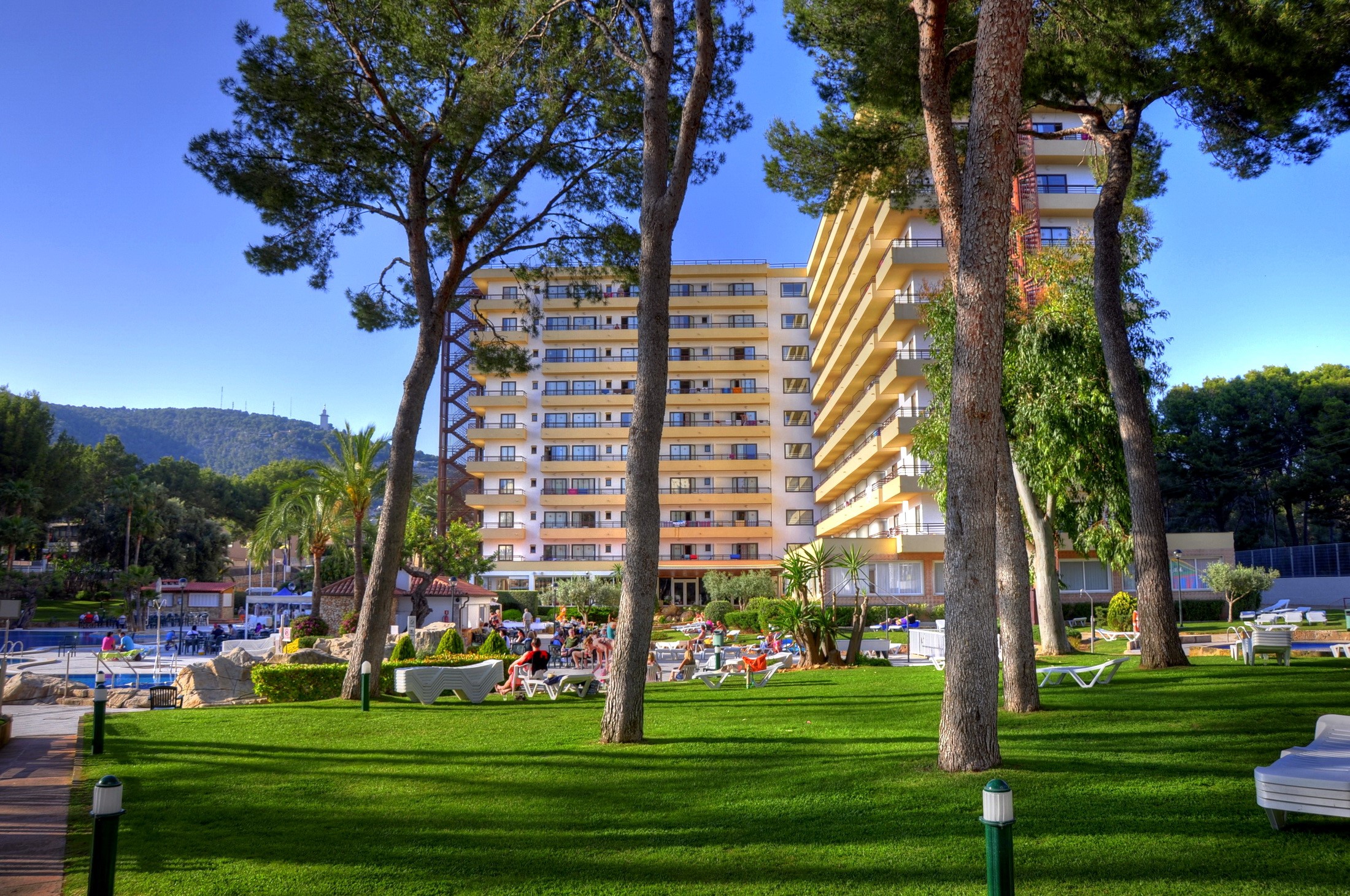 Hotel with pool and trees in Spain HD Wallpaper