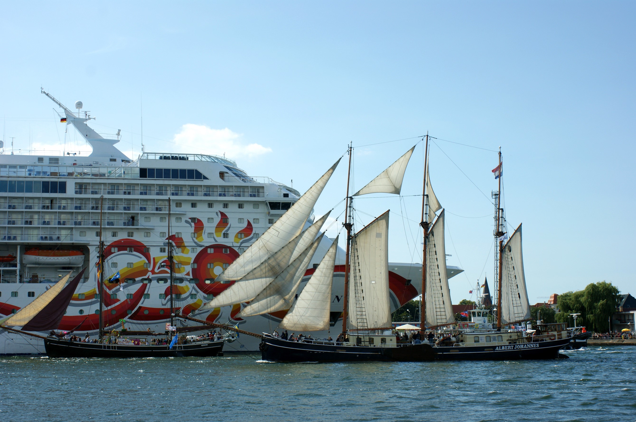 Cruise ship and sailing ships on the water HD Wallpaper