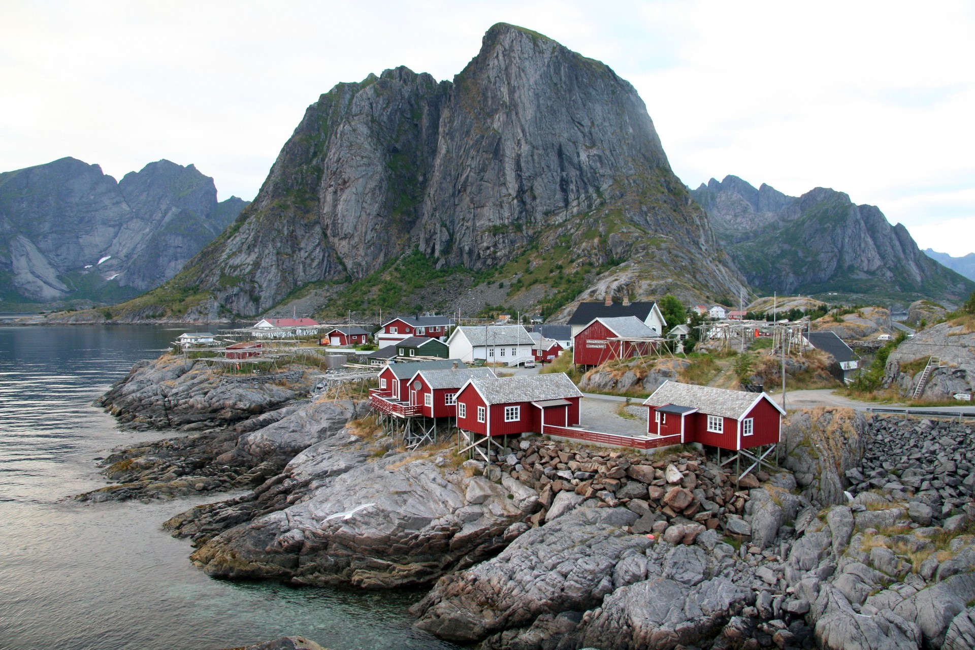 Red fishing cabins on rocky coast in Norway HD Wallpaper