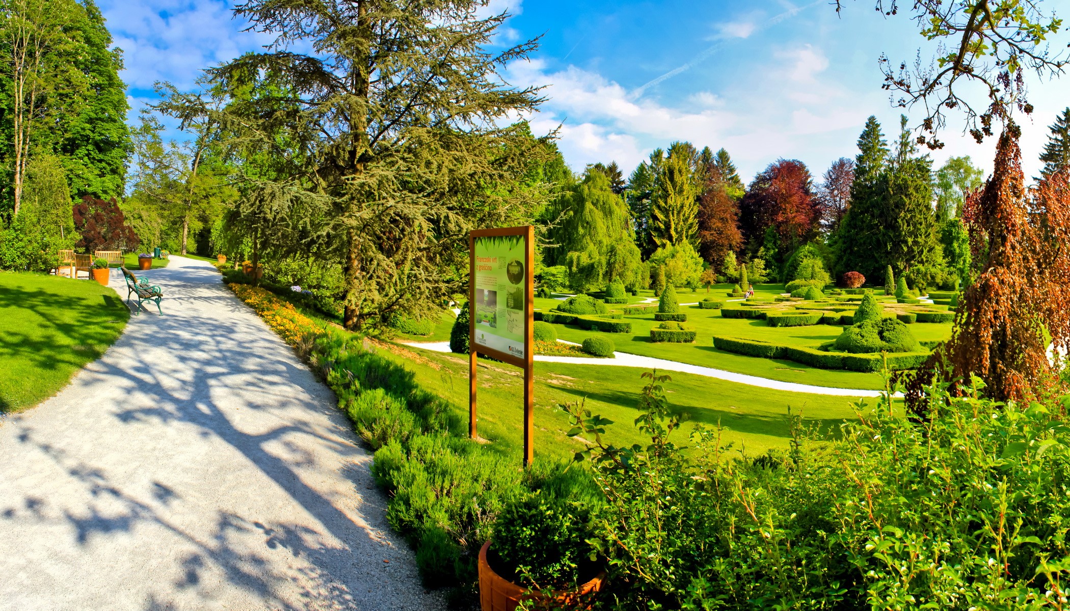 Formal garden with manicured hedges and trees HD Wallpaper
