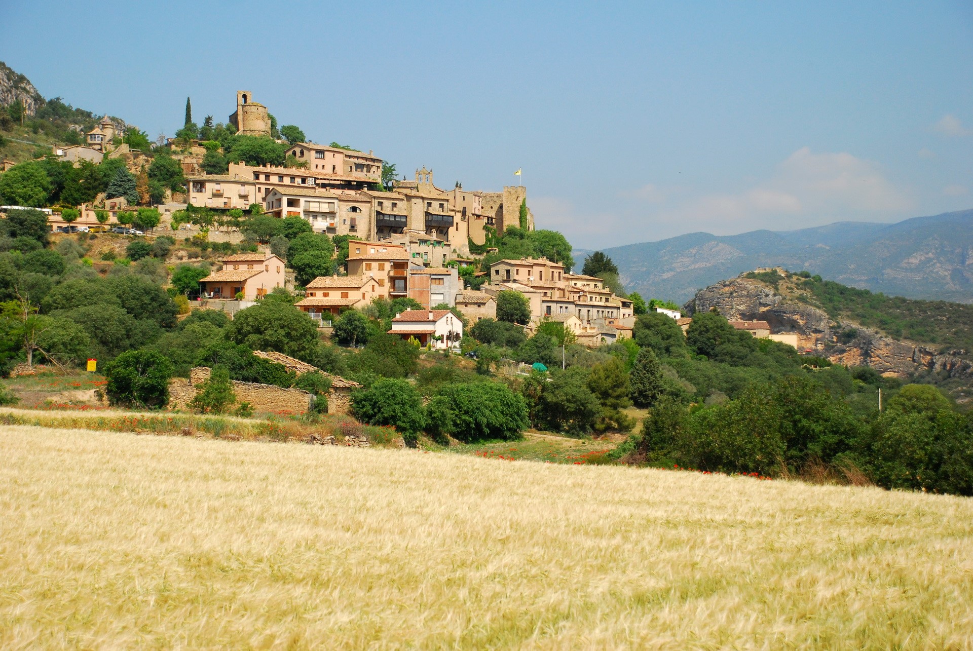 Village on a hill in Spain with wheat field HD Wallpaper