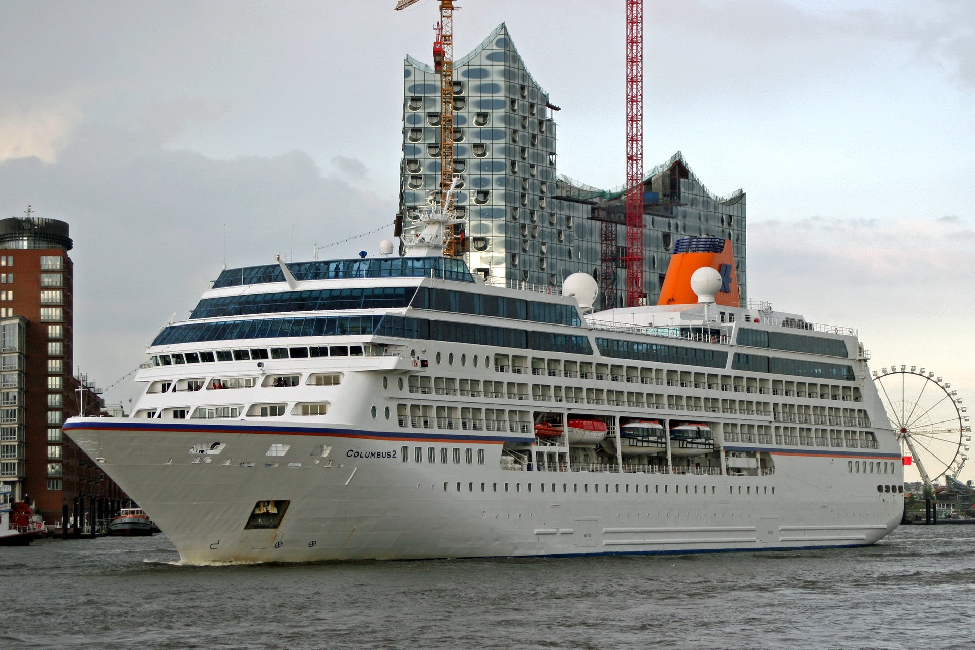 Cruise liner Columbus 2 in a harbor with modern buildings HD Wallpaper