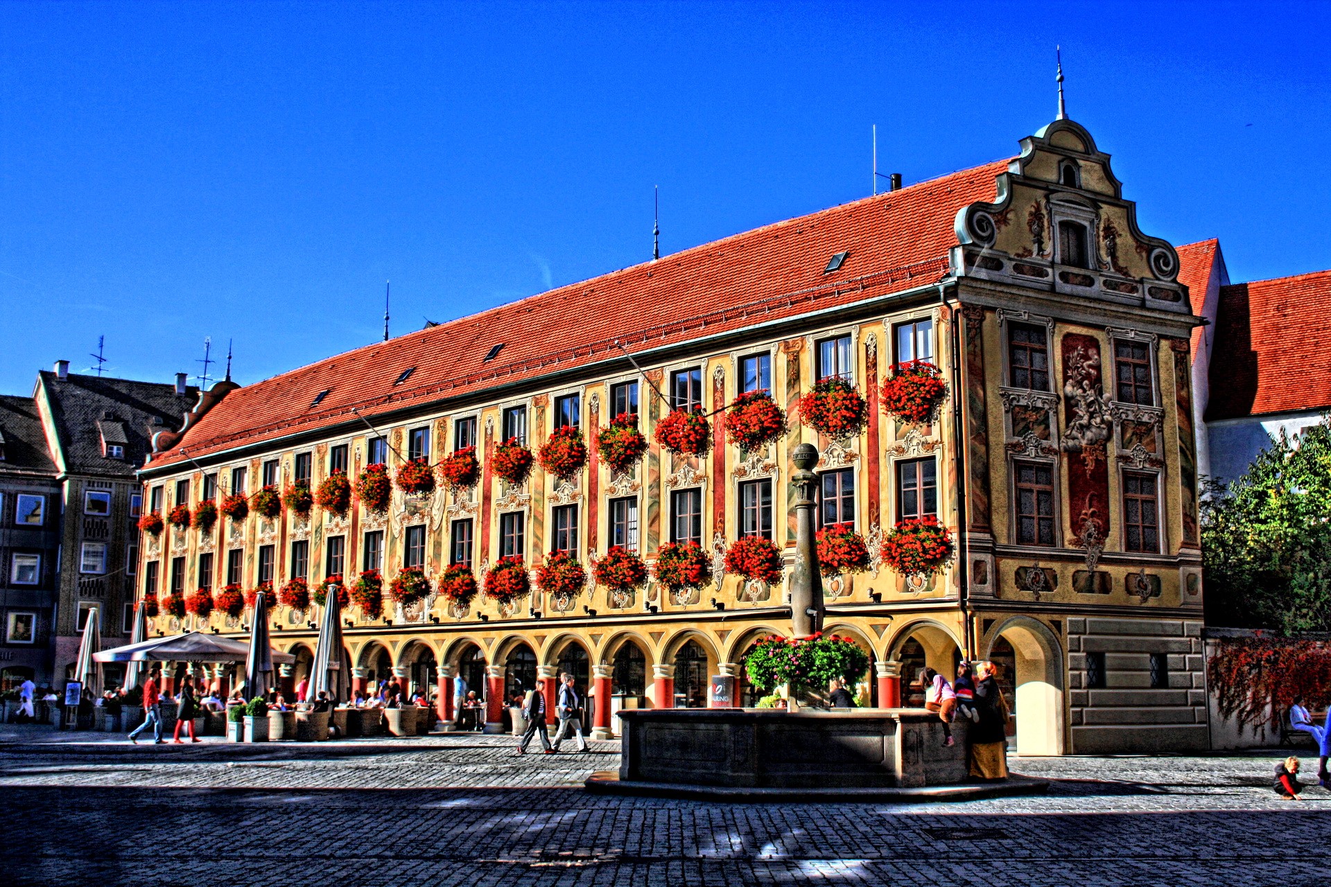 Building with arched walkways and flower boxes in Germany HD Wallpaper