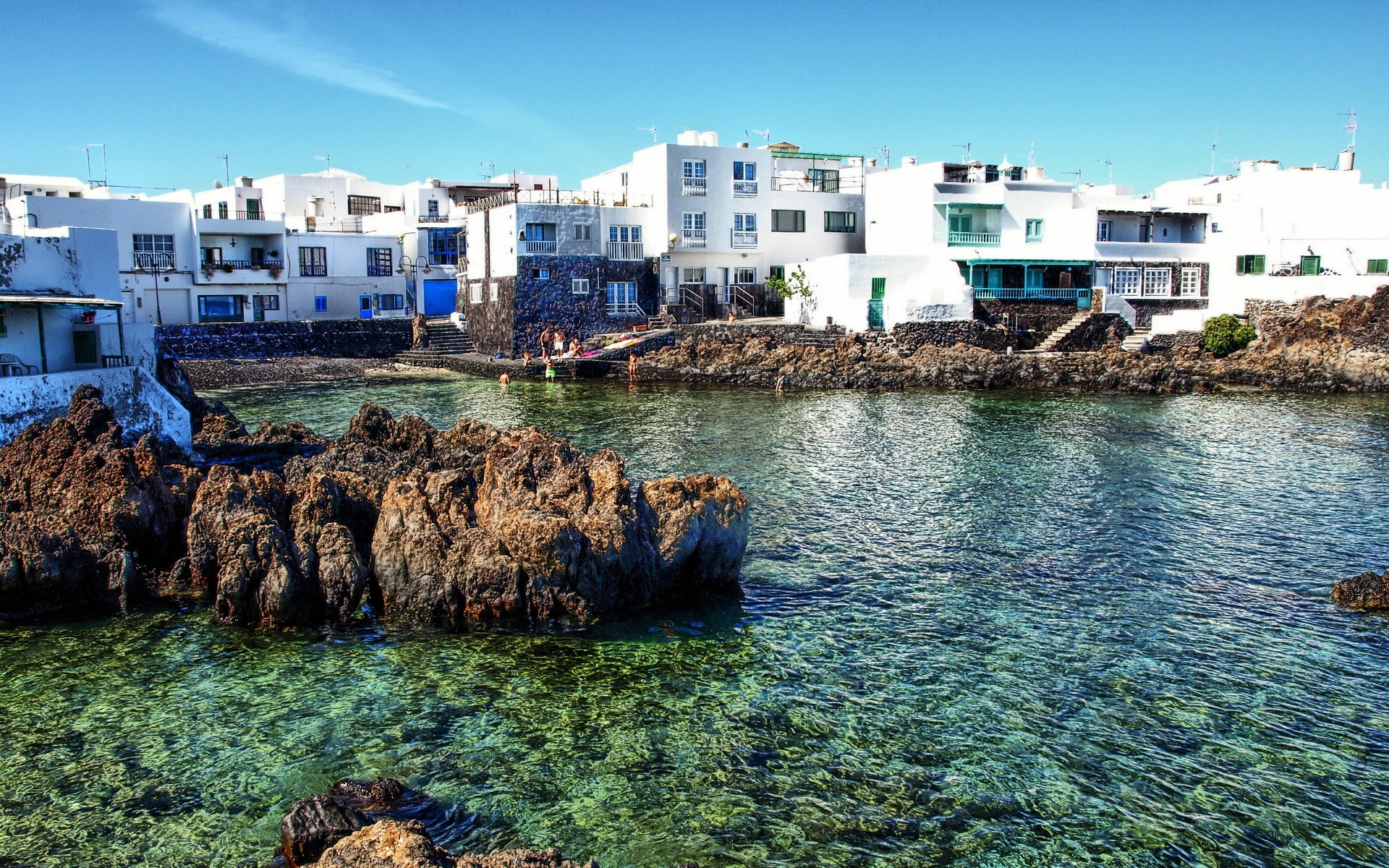 Coastal village with white buildings and clear water in the Canary Islands HD Wallpaper