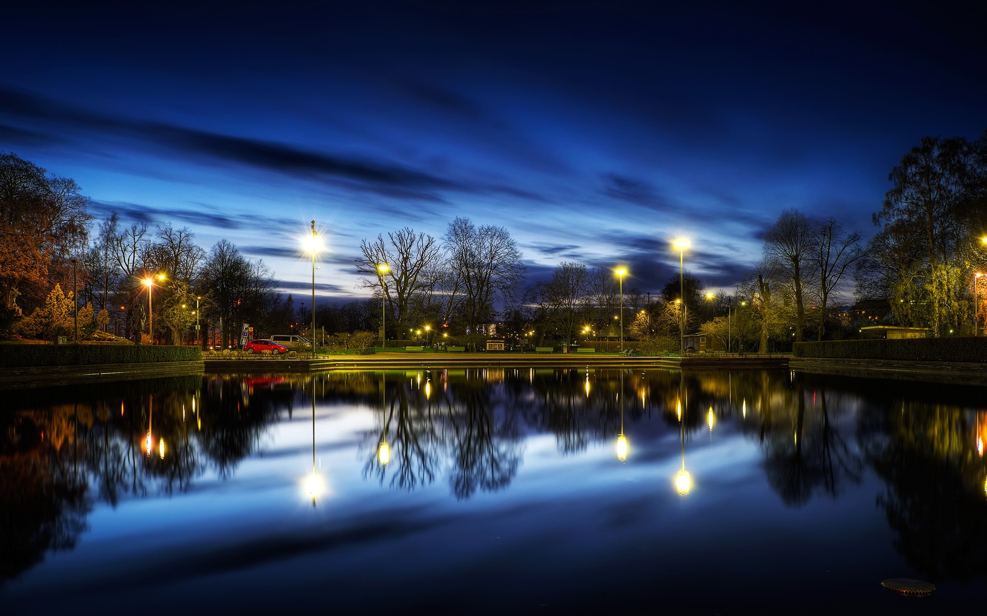 Park with pond and streetlights at dusk HD Wallpaper