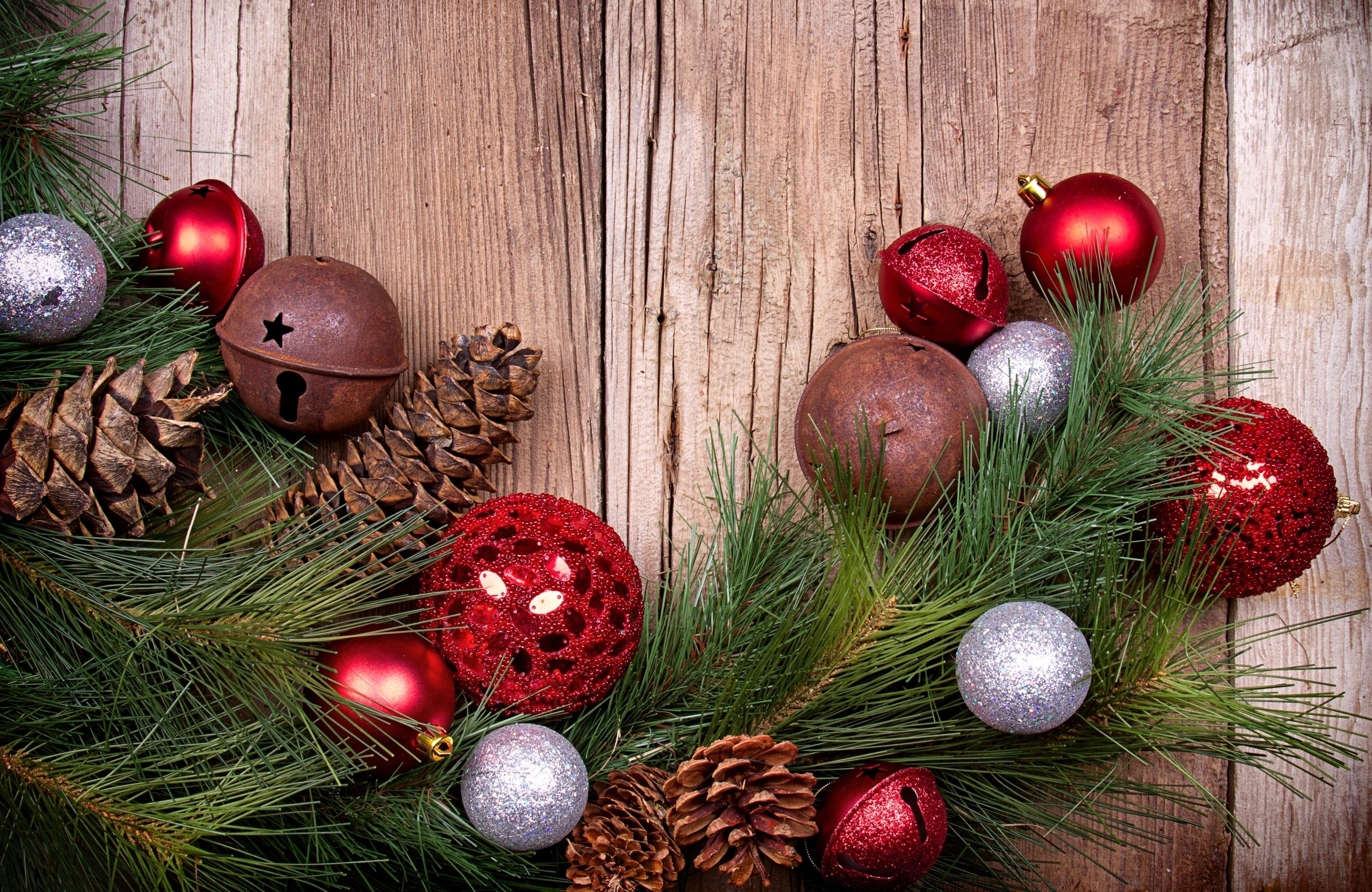 Christmas ornaments and pine cones on wooden background HD Wallpaper